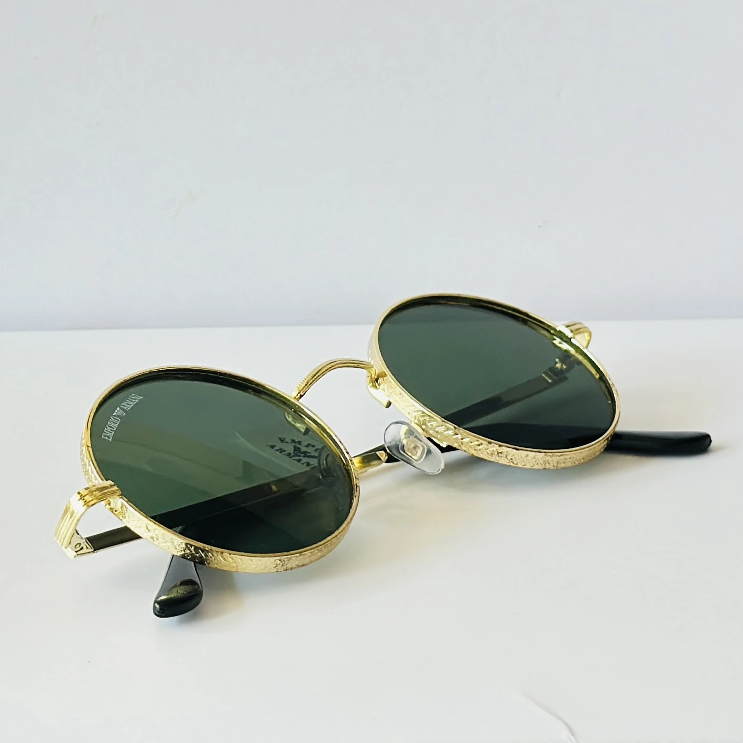 sunglasses are Emporio Armani round-frame