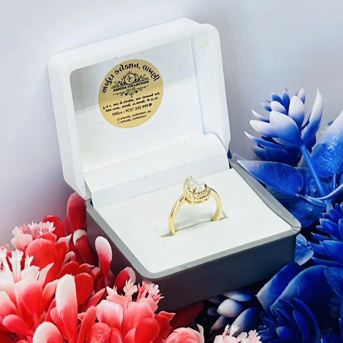 Yellow gold pear-shaped diamond halo ring.