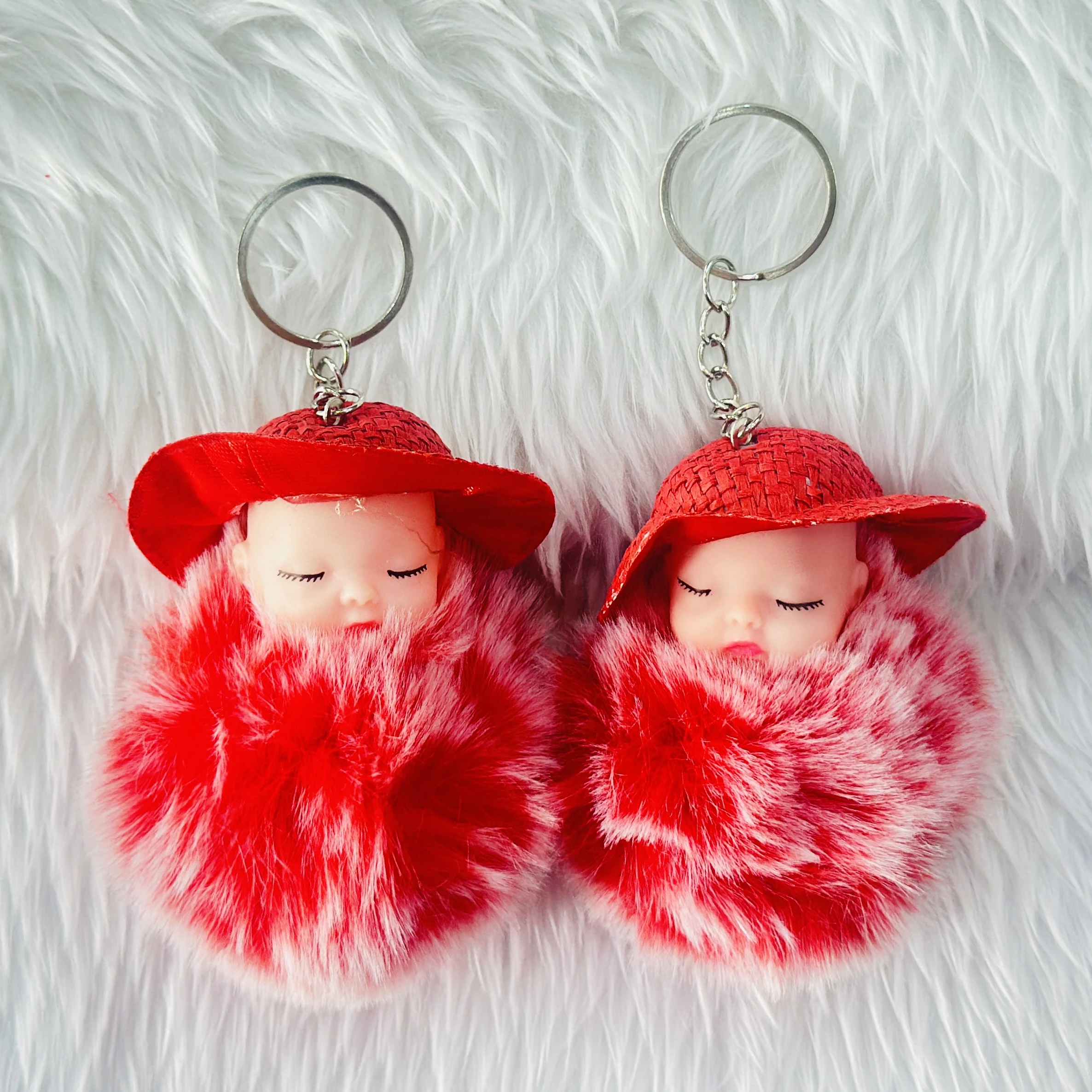 fluffy charm is a red and white SRG sleeping baby doll keychain