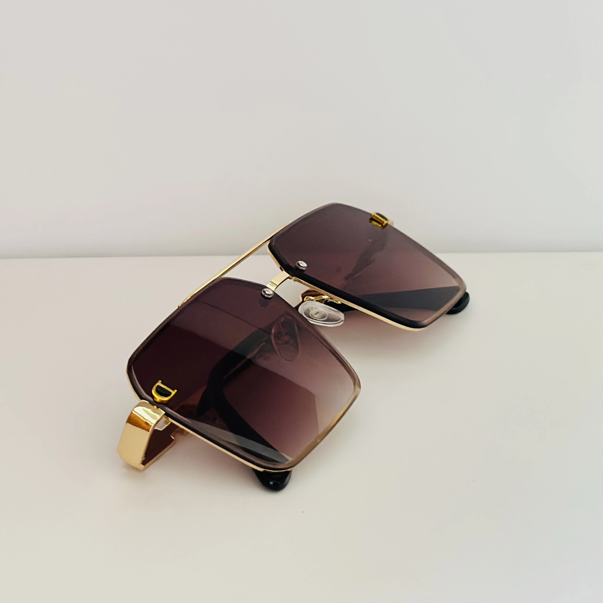 Gold Frame brown gradient lens oversized square sunglasses with black temple arms.