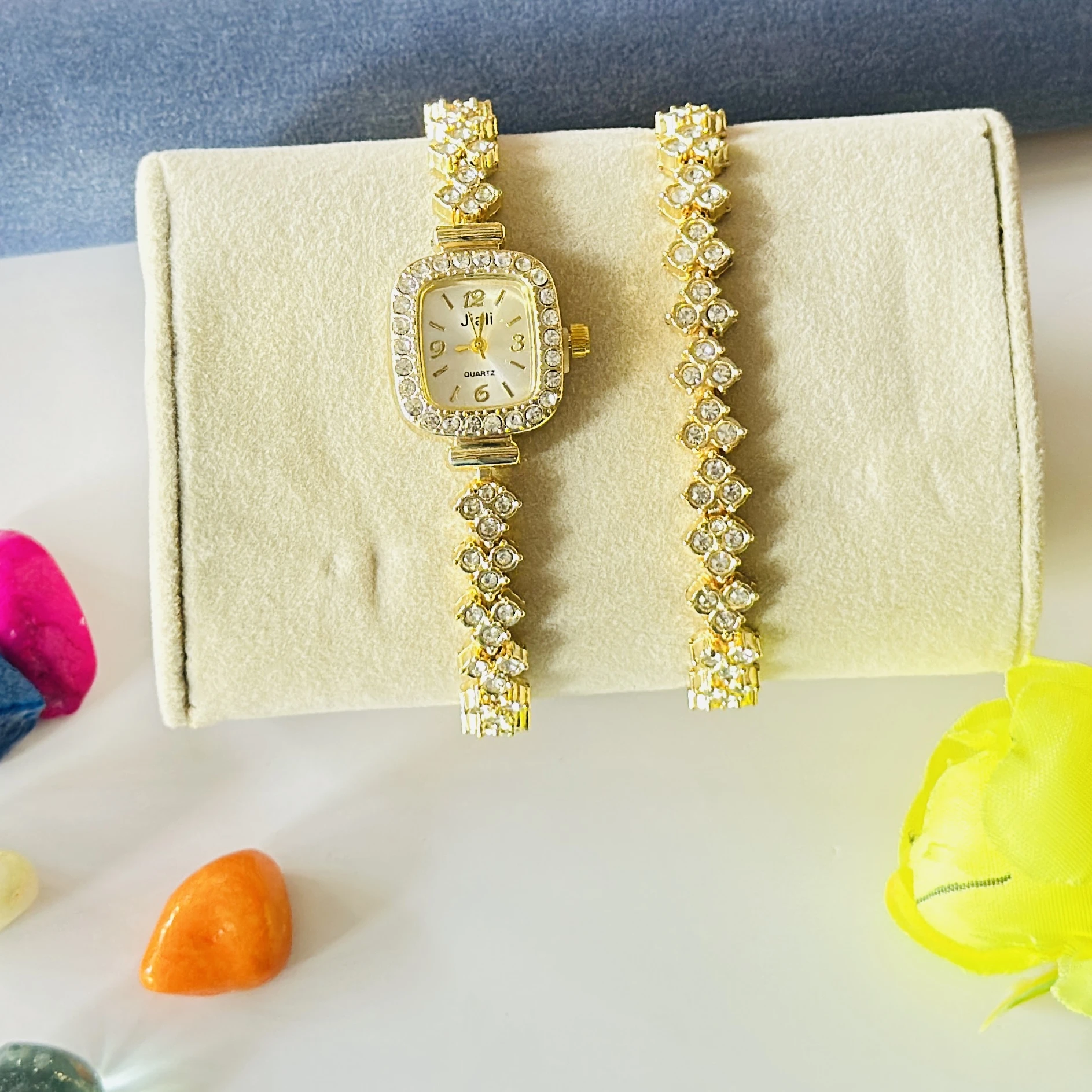 gold-tone Jiali quartz watch with a square dial and rhinestones.