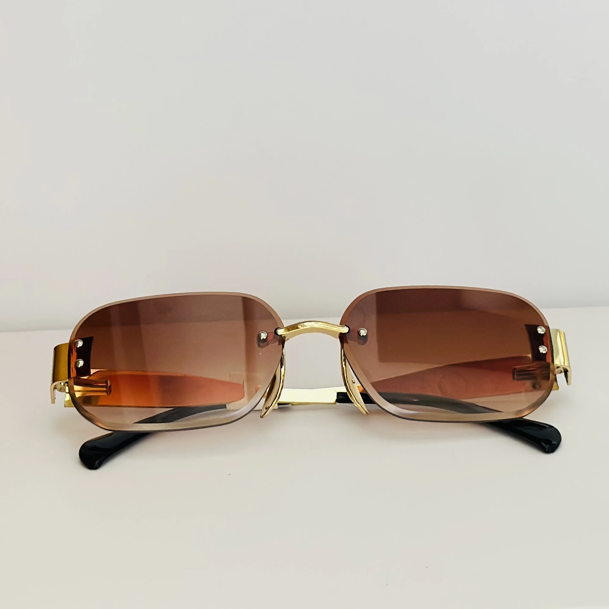 Rimless fashion sunglasses with brown gradient lenses and gold-toned hardware