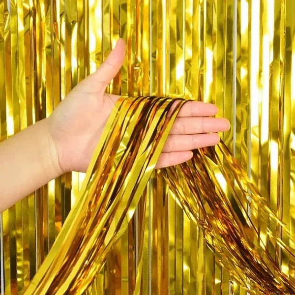 PartyPal gold foil fringe curtain backdrop for party decorations.