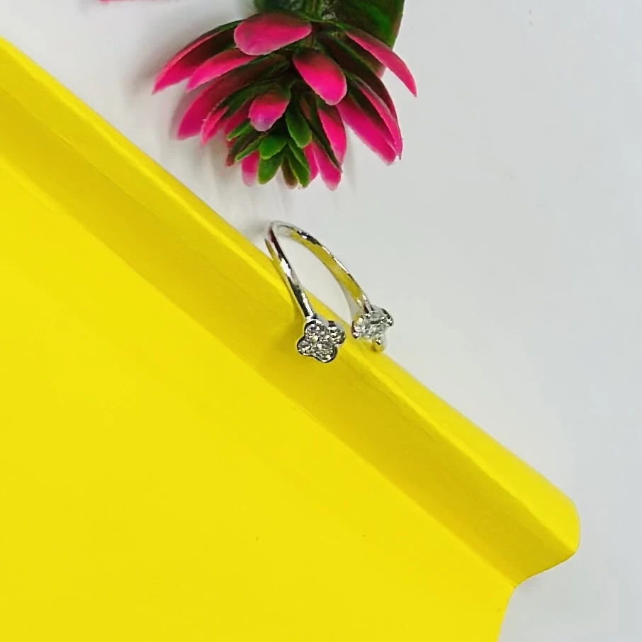 Silver bypass ring featuring lab-grown diamond floral clusters.