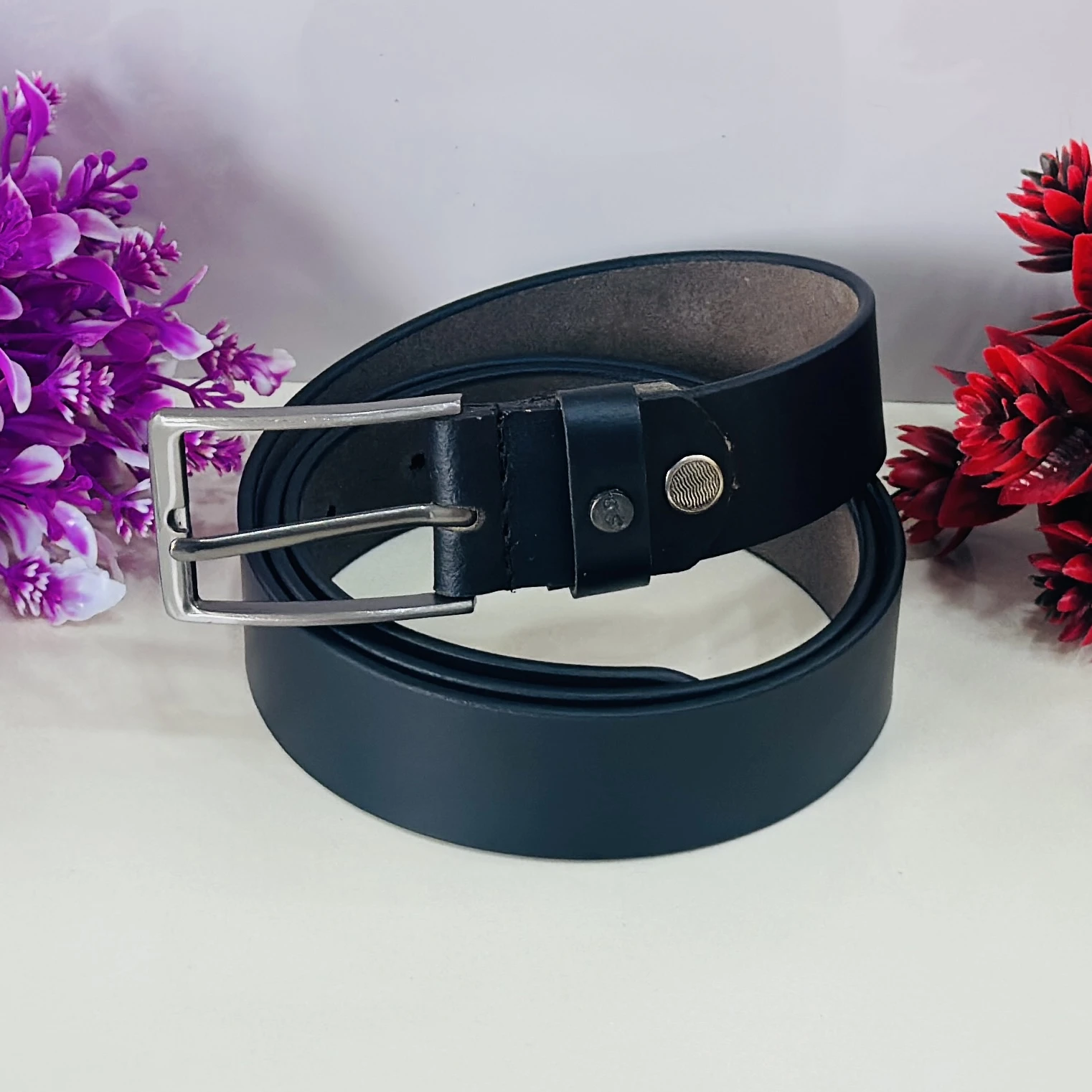 Black leather belt with a silver-tone pin buckle.