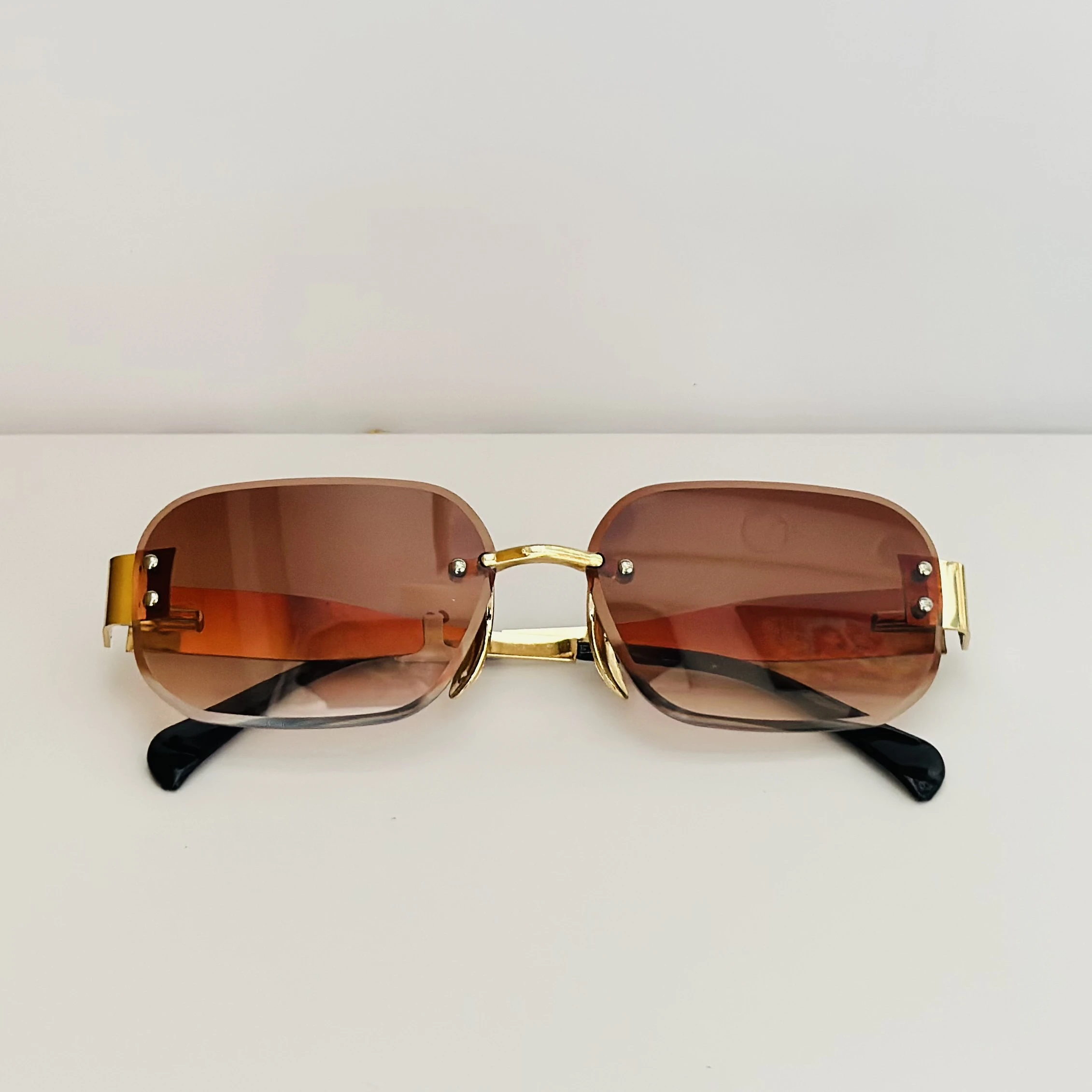 Rimless fashion sunglasses with brown gradient lenses and gold-toned hardware