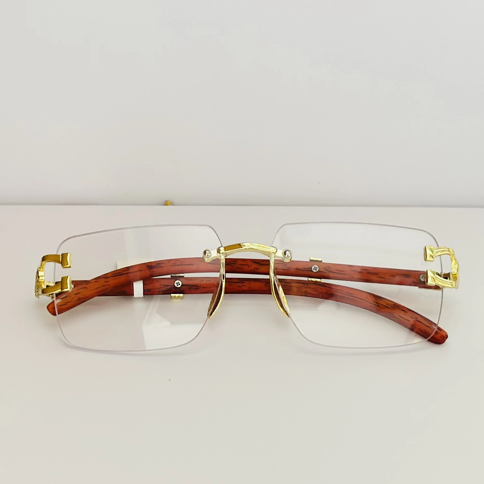 Street Knitted men's rimless gold frame glasses with clear lenses and a woodgrain finish on the arms.