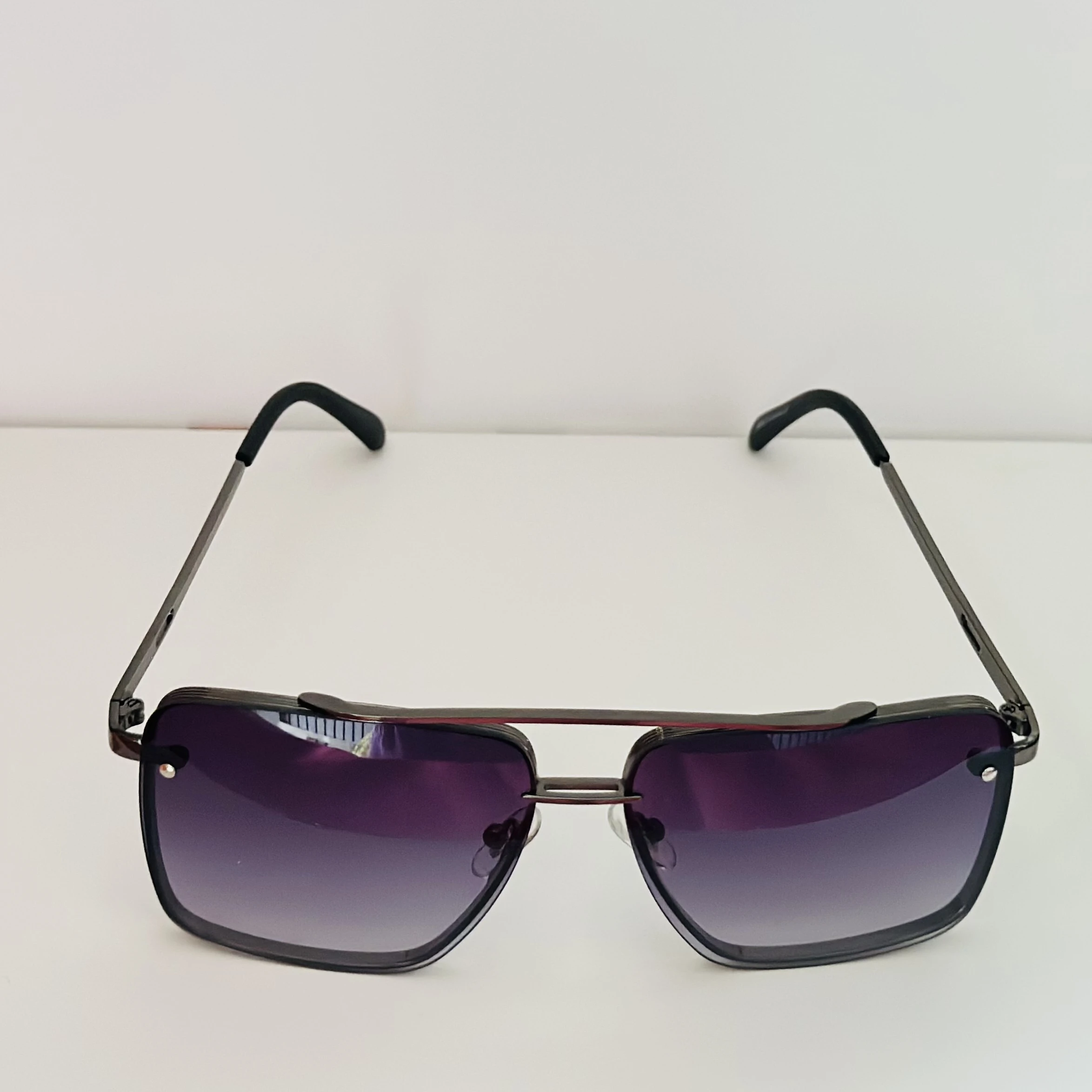 Black metal-framed square sunglasses with gradient lenses.