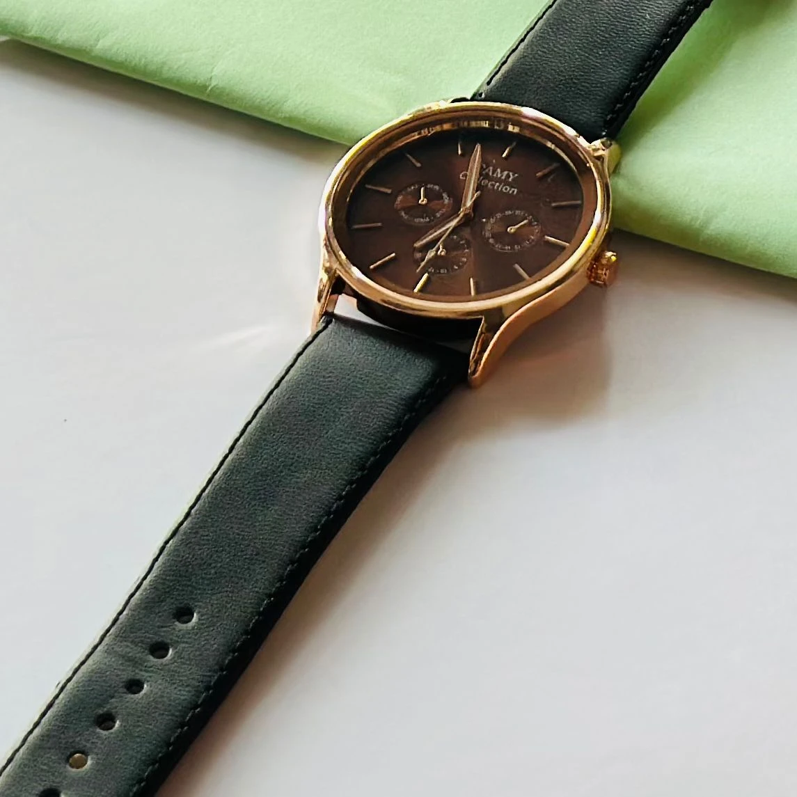 Round  analog watch with a black  leather strap