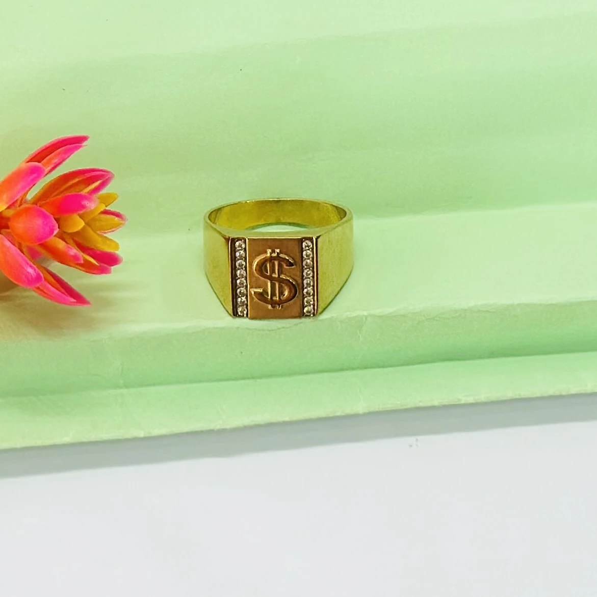 Men’s 14k gold dollar sign ring with side stones.