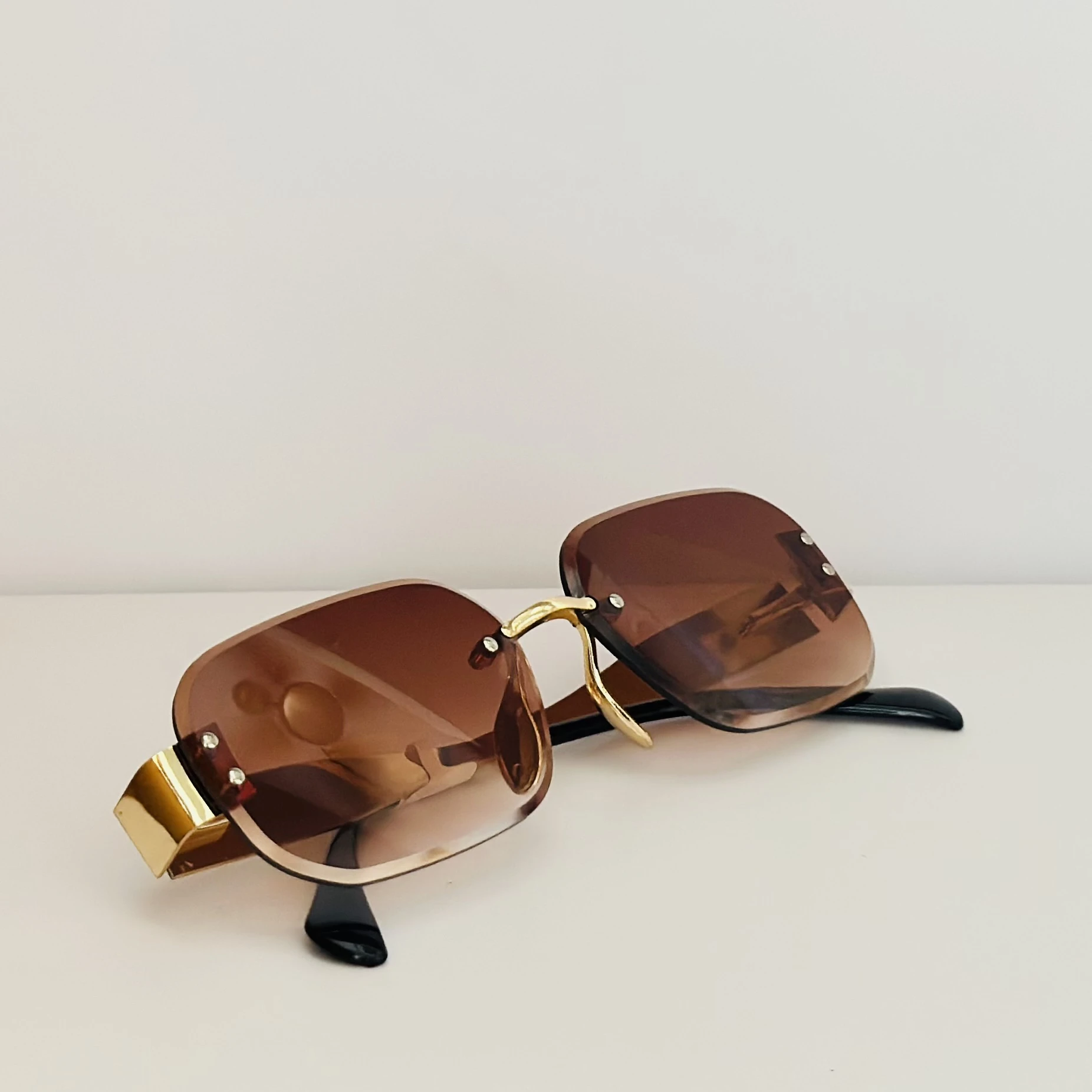 Rimless fashion sunglasses with brown gradient lenses and gold-toned hardware