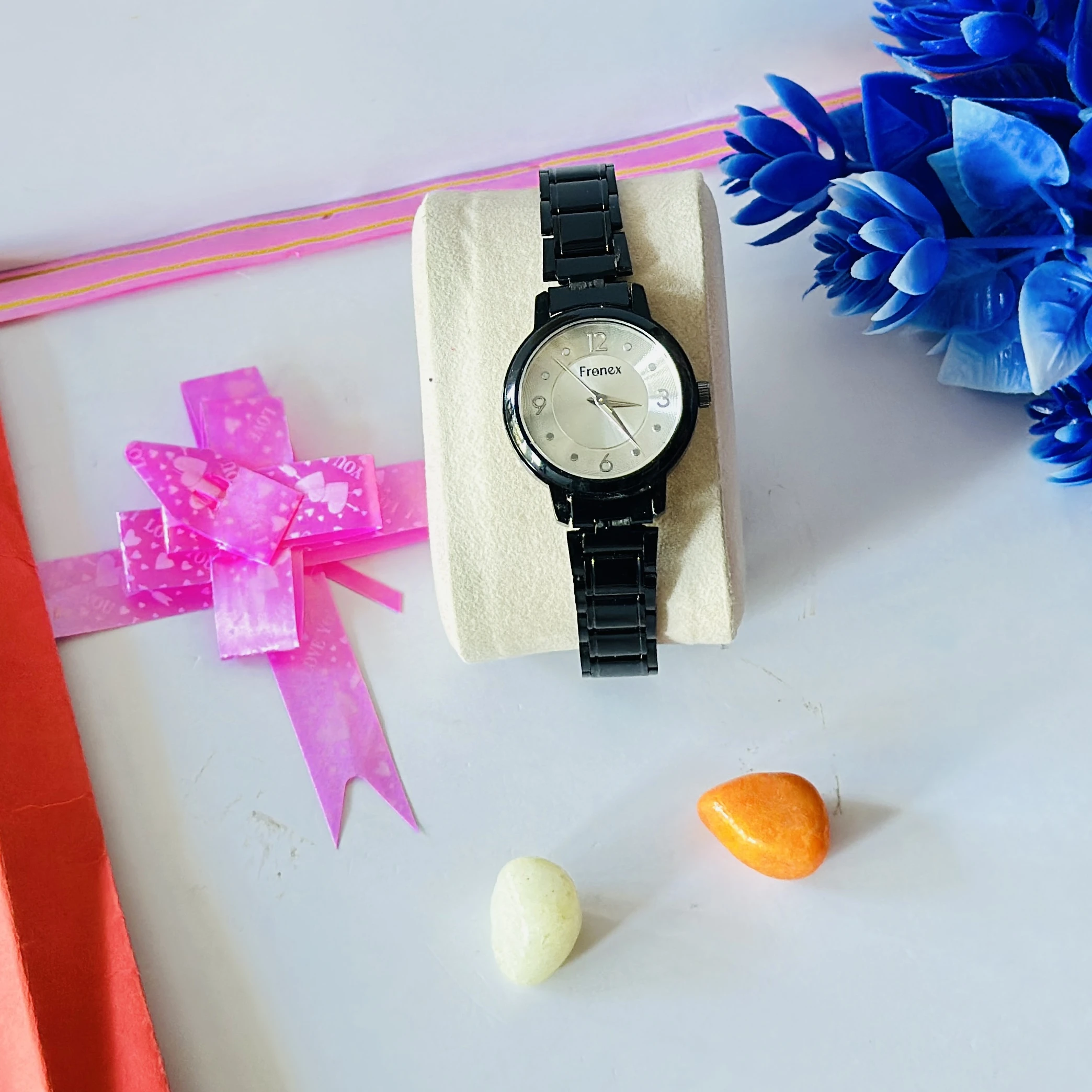appears to be a black analog wristwatch for women