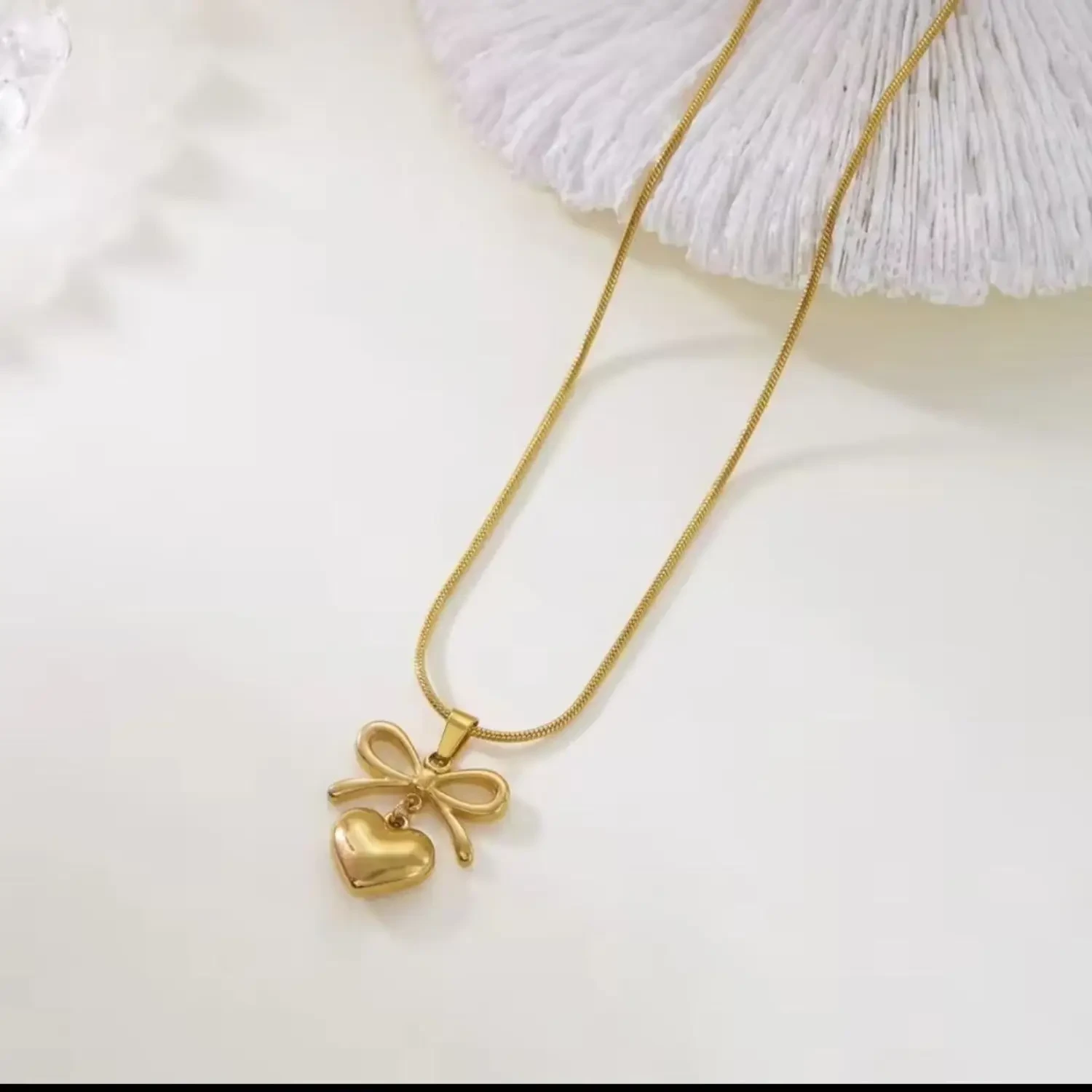 Lumora Forever Gleaming necklace features a heart and bow pendant