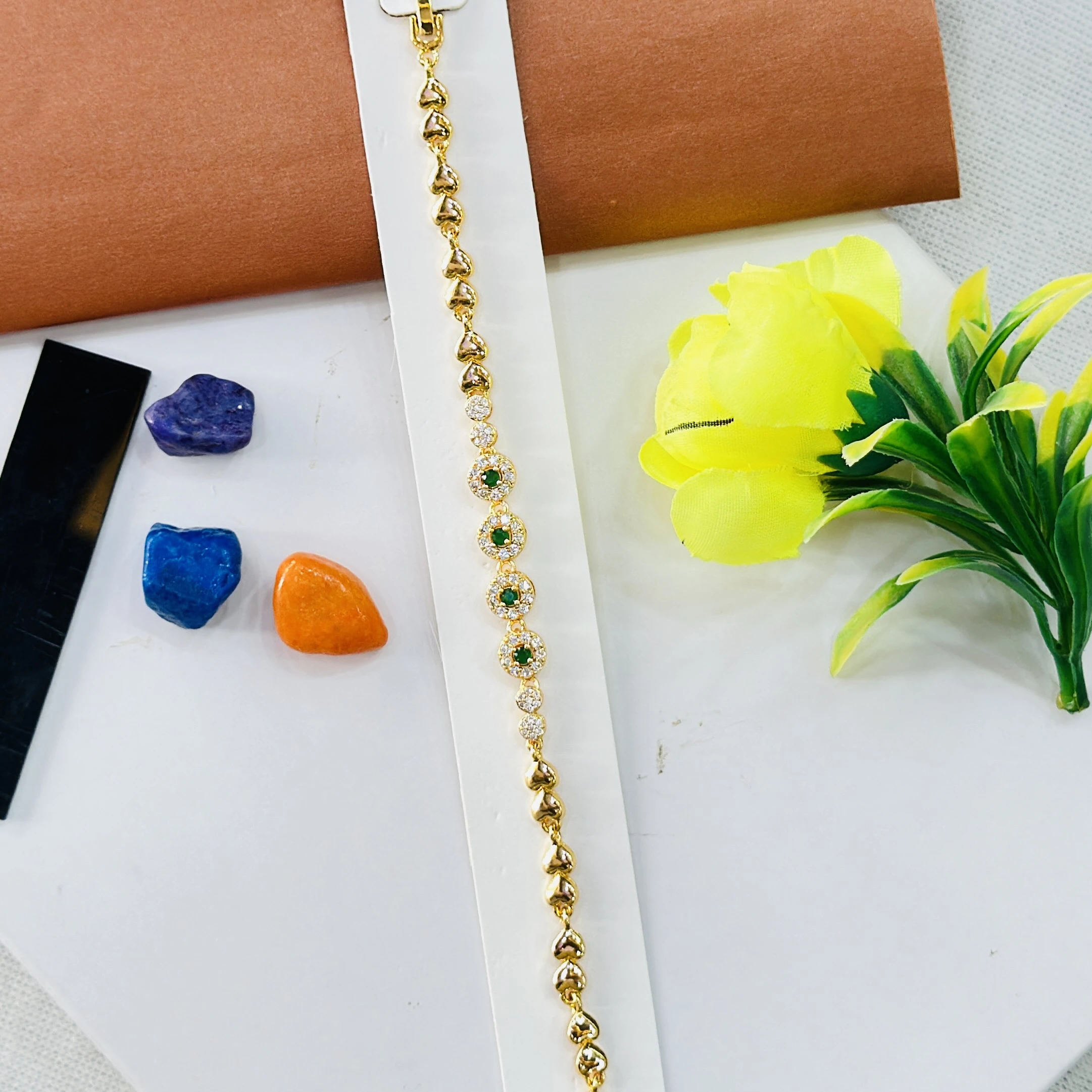 Gold plated bracelet with green and white stones