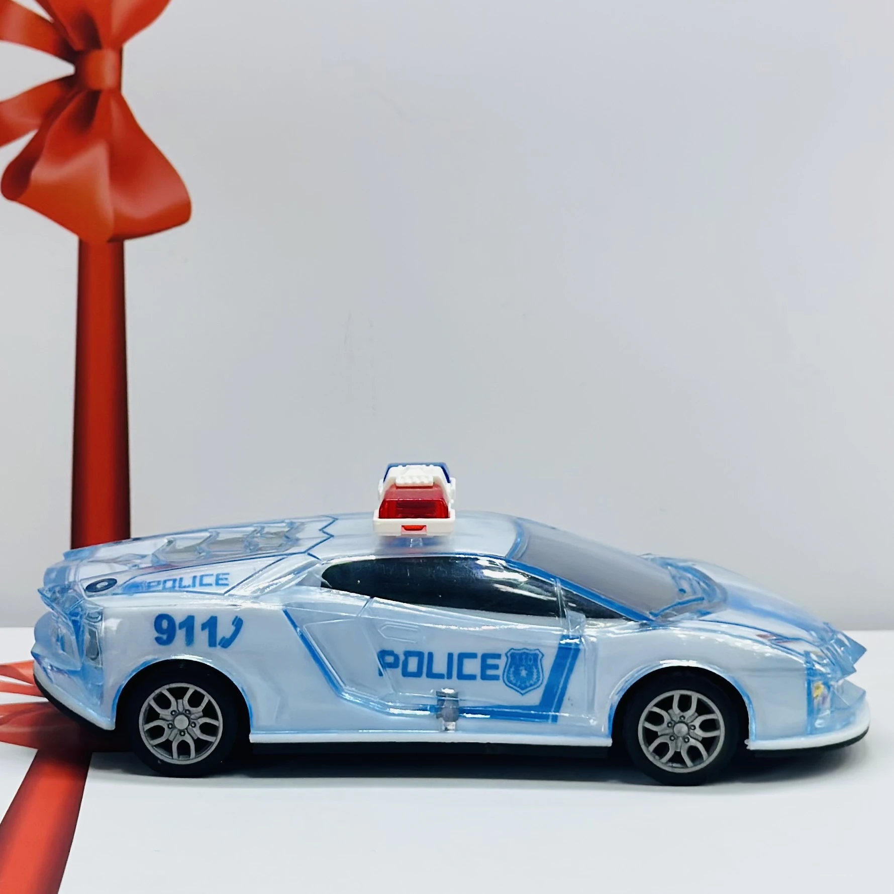 Toy police car with a transparent body and light-up features.