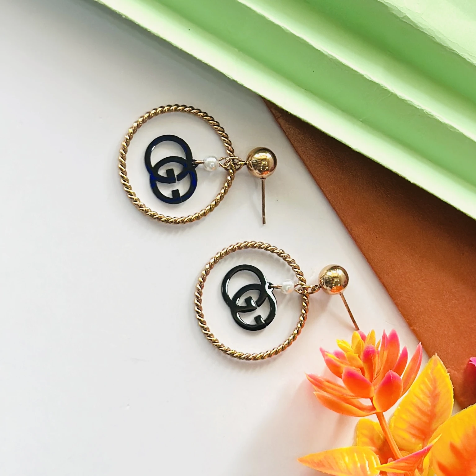 Gold toned and black fashion hoop earrings