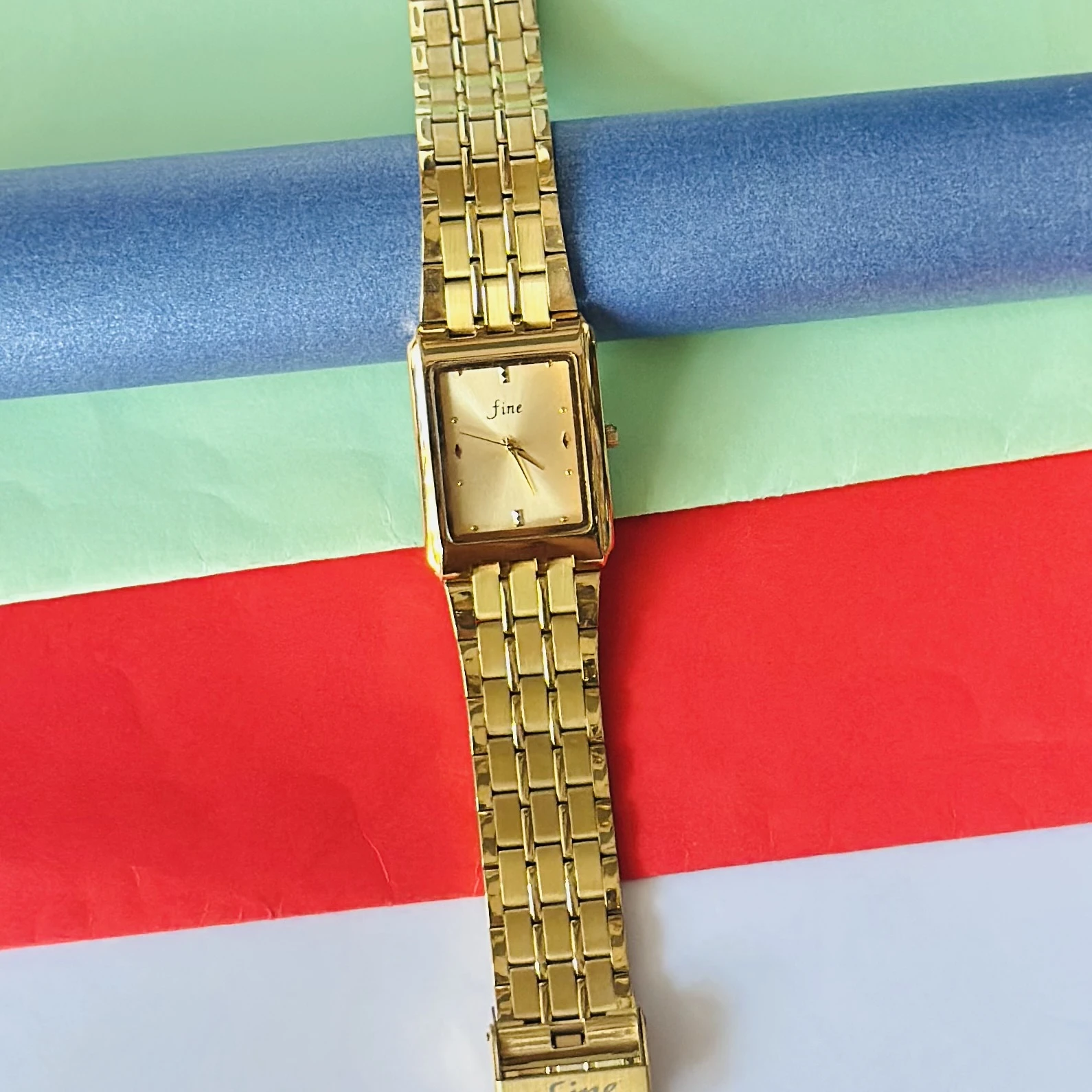 Gold -tone analog quartz watch with a metal strap.