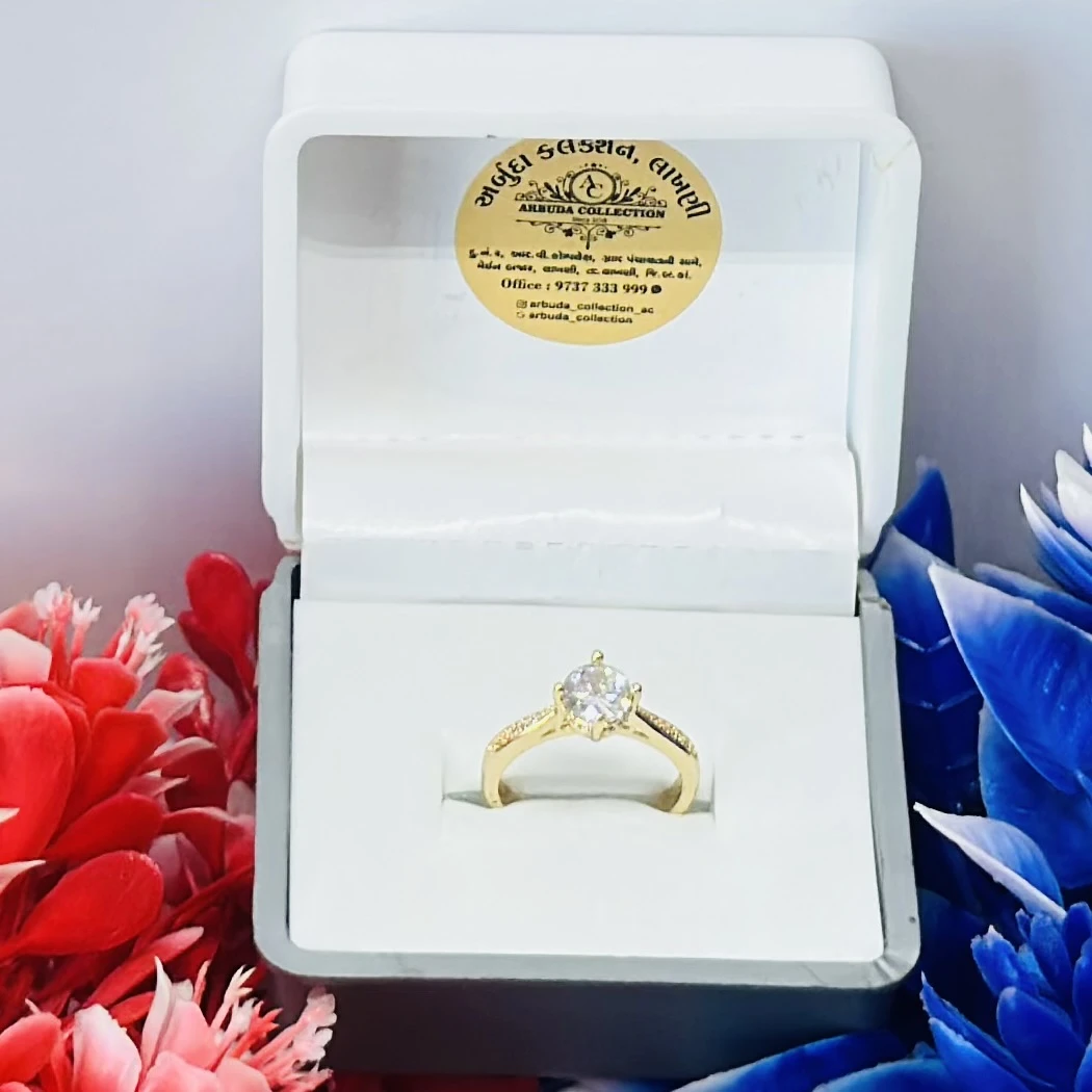 Yellow gold engagement ring with a central stone and side accents.