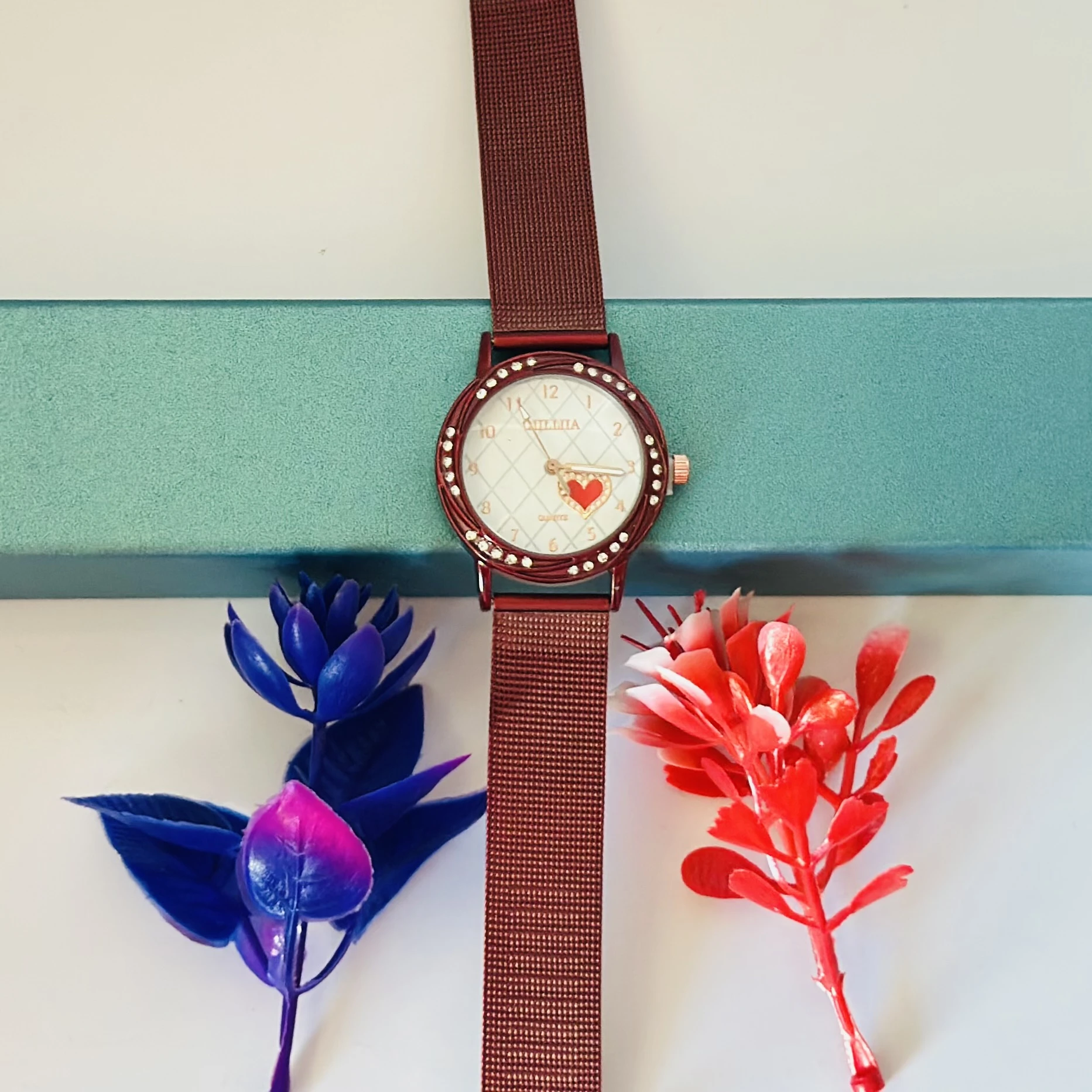 analog watch with a Red magnetic strap