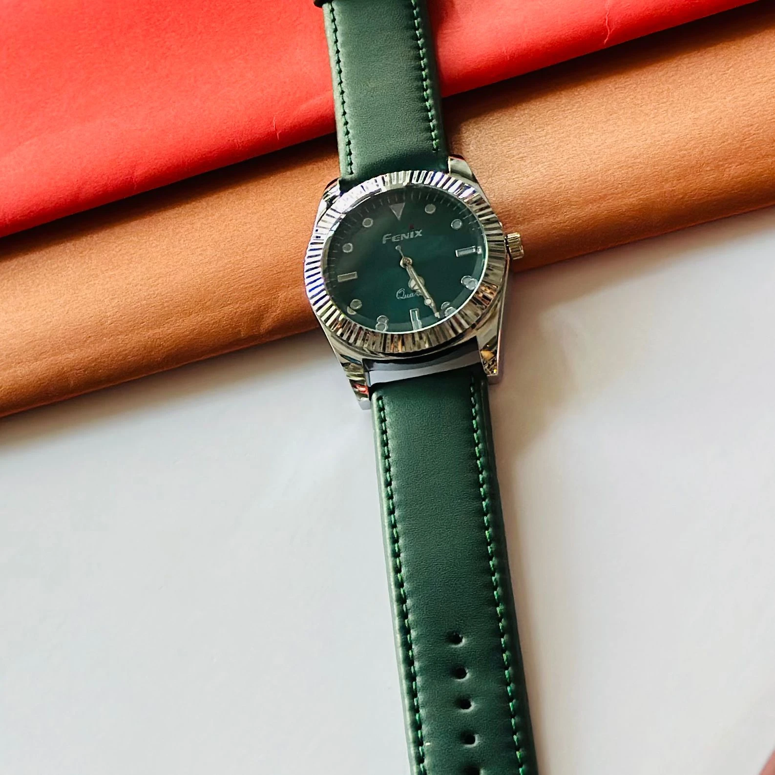 Round analog watch with a Green  leather strap