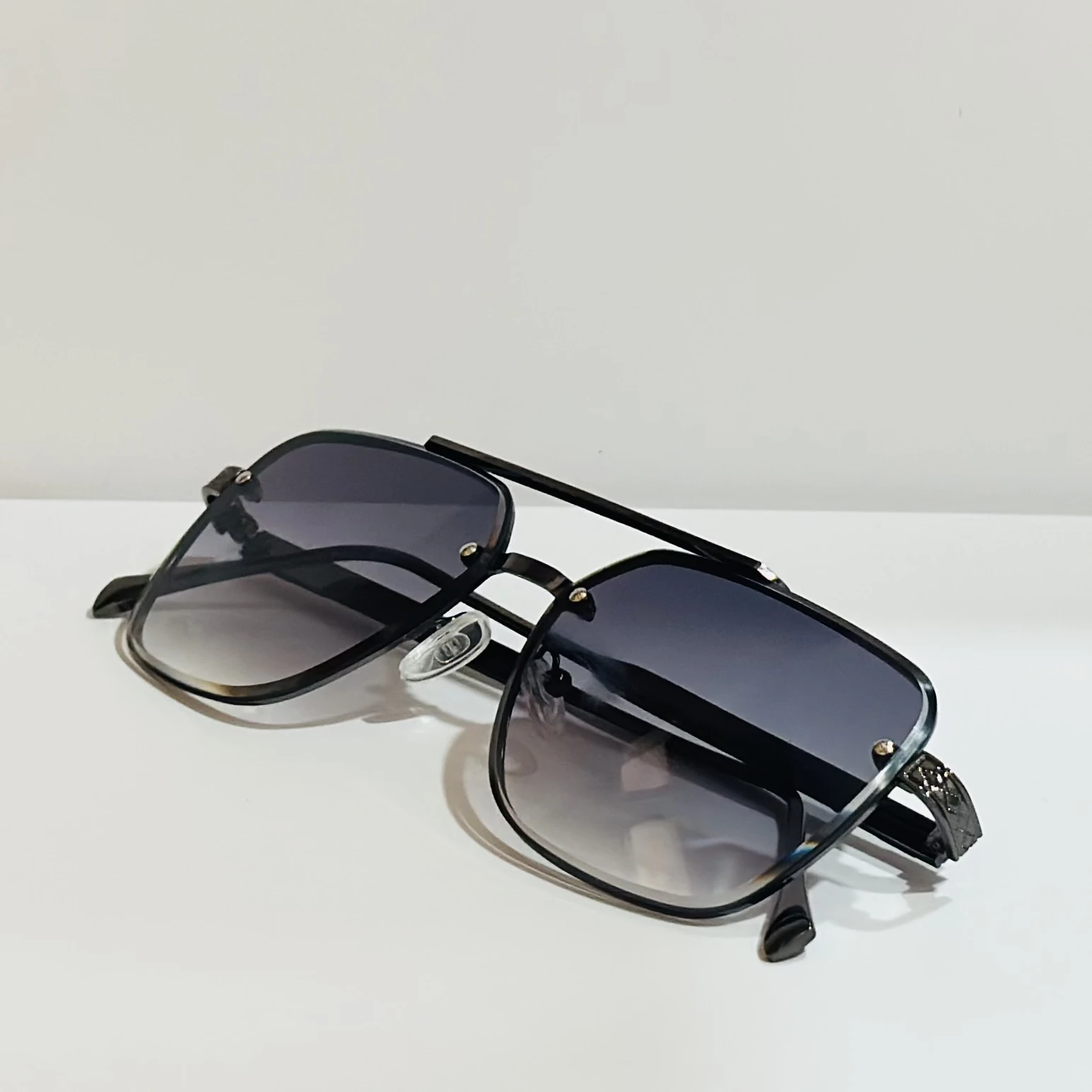pair of black and grey gradient square sunglasses with a metal frame.