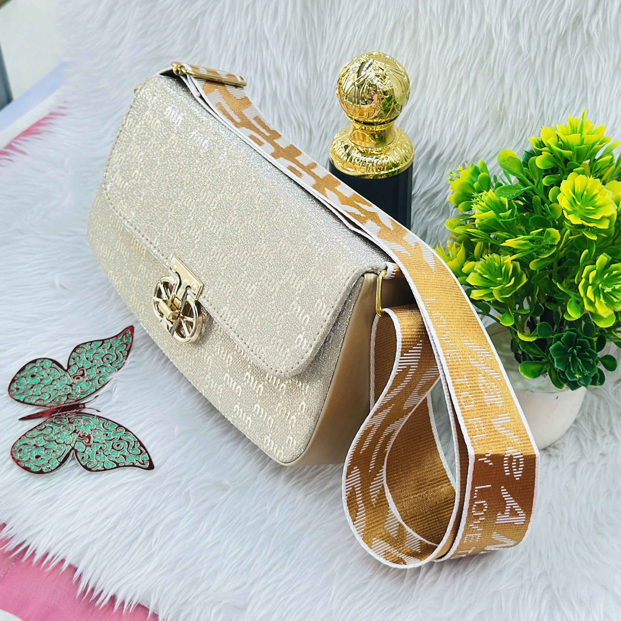 Gold colored, glittery structured handbag