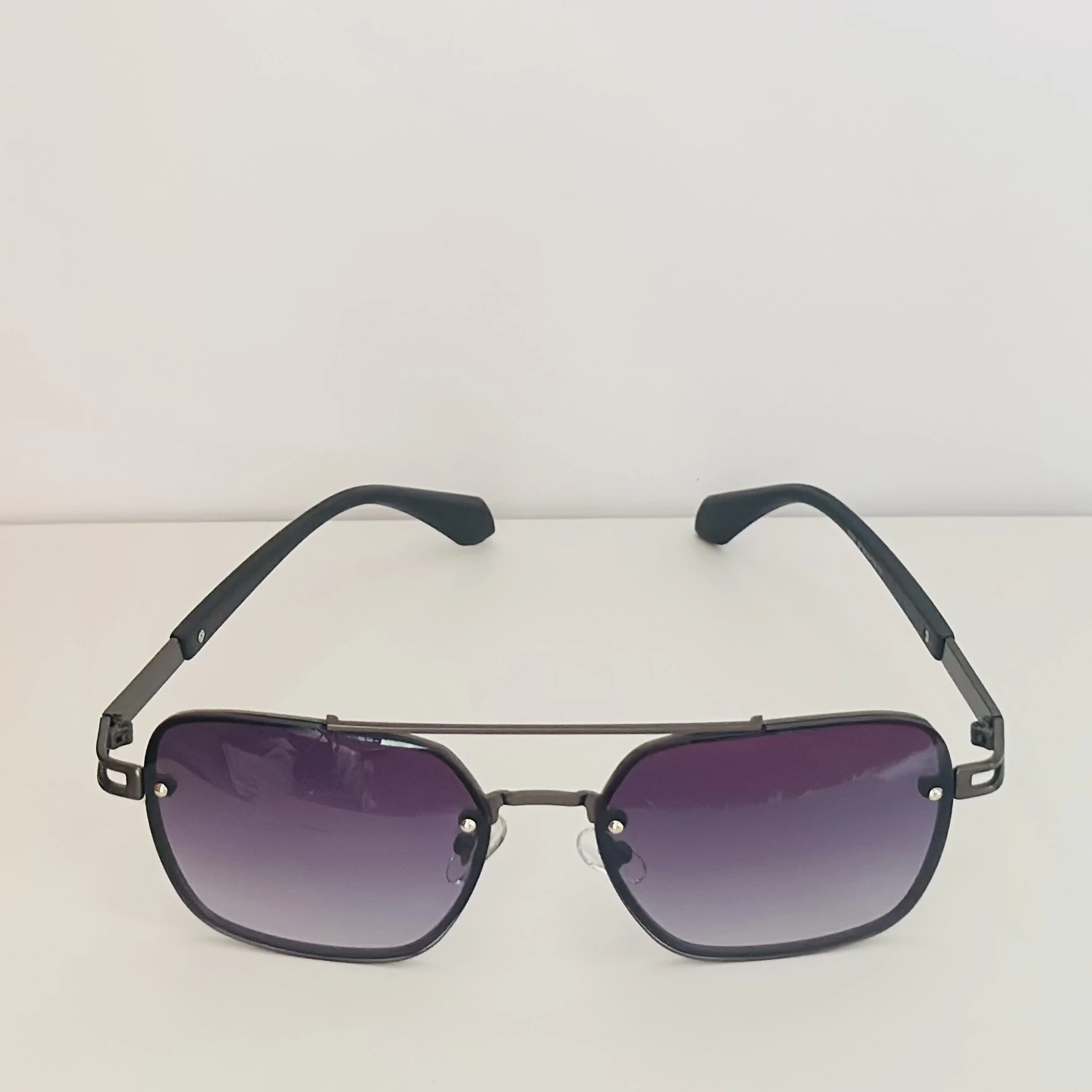 pair of Maybach square-style sunglasses with a black metal frame and dark gradient lenses