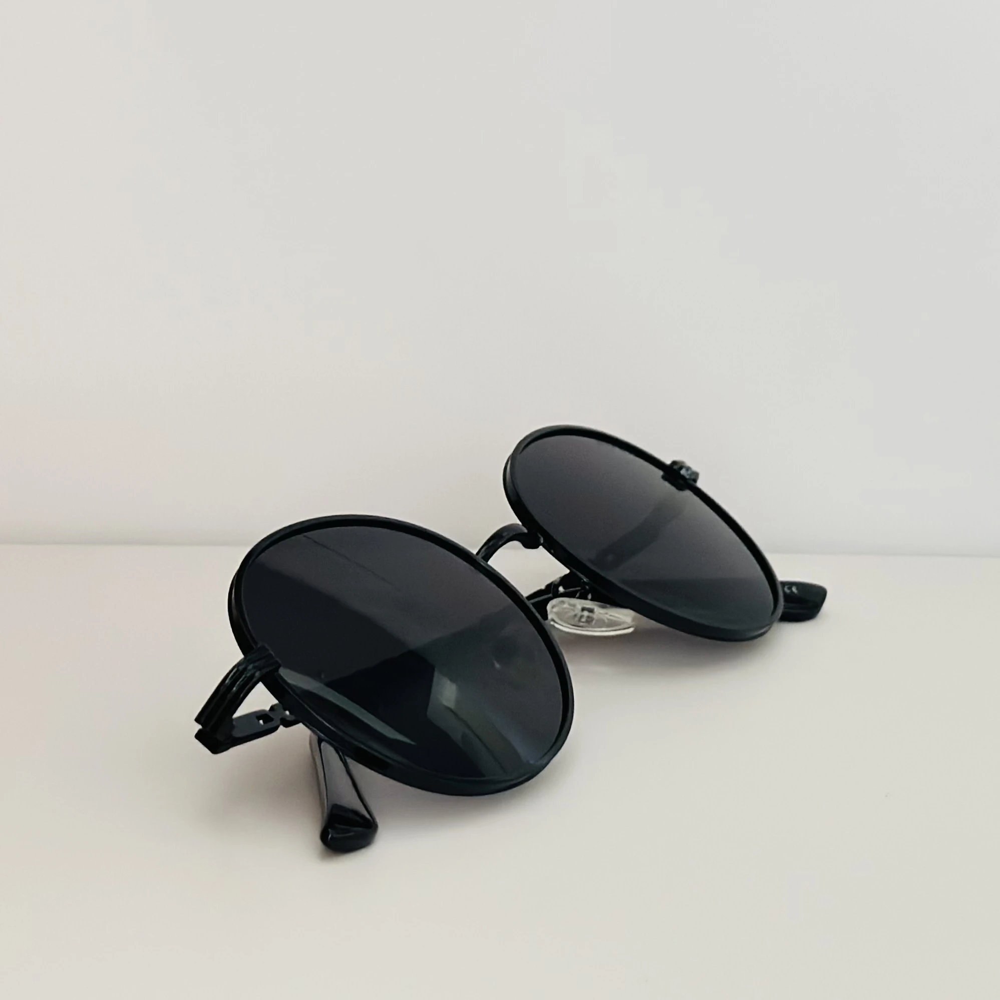 Moncler Tatou ML 0224 sunglasses in black metal with round lenses.