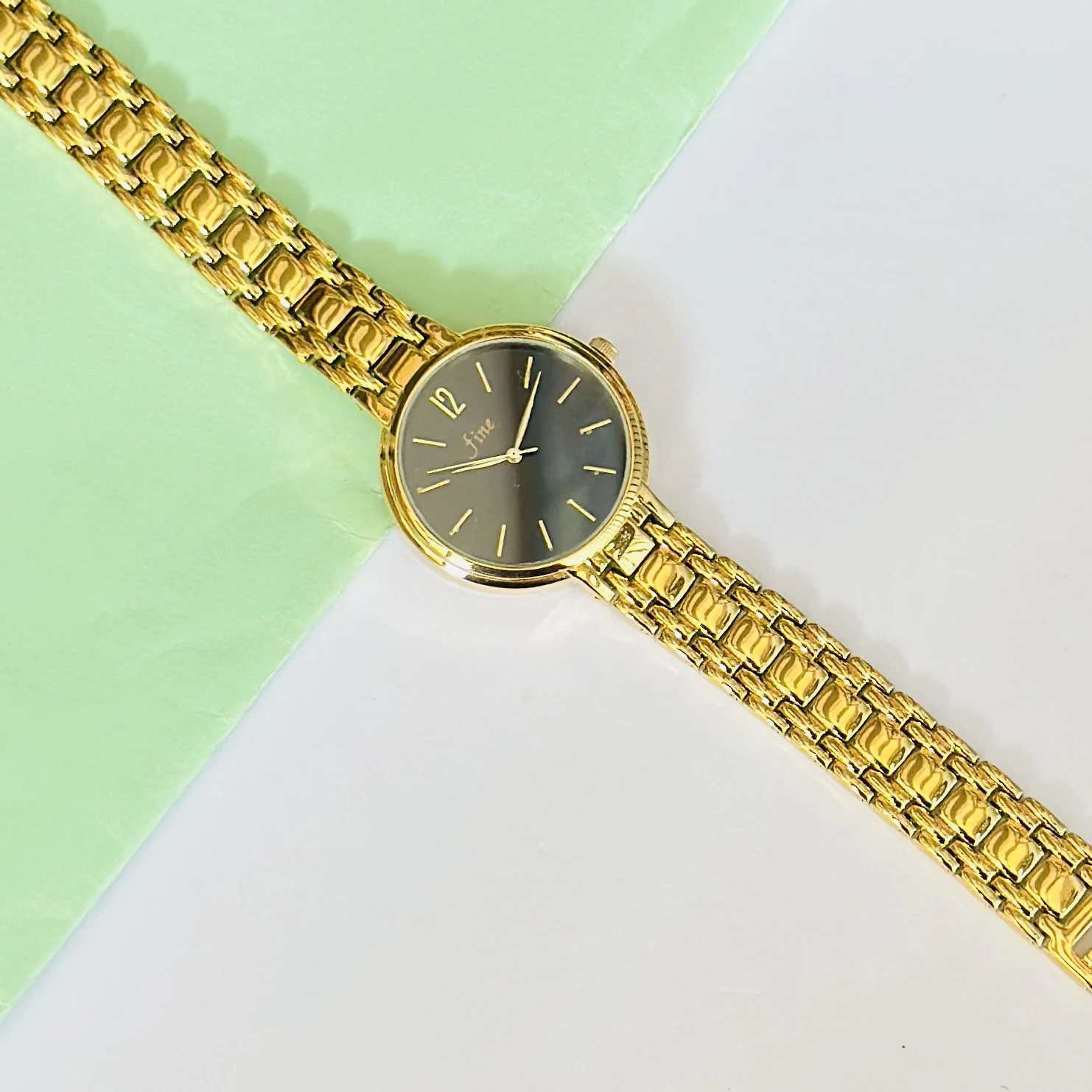 Gold tone metal strap watch