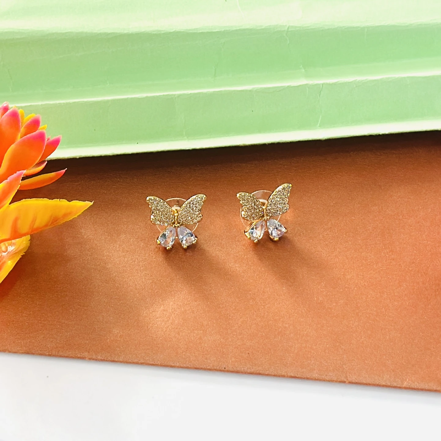 Gold toned, butterfly-shaped stud earrings