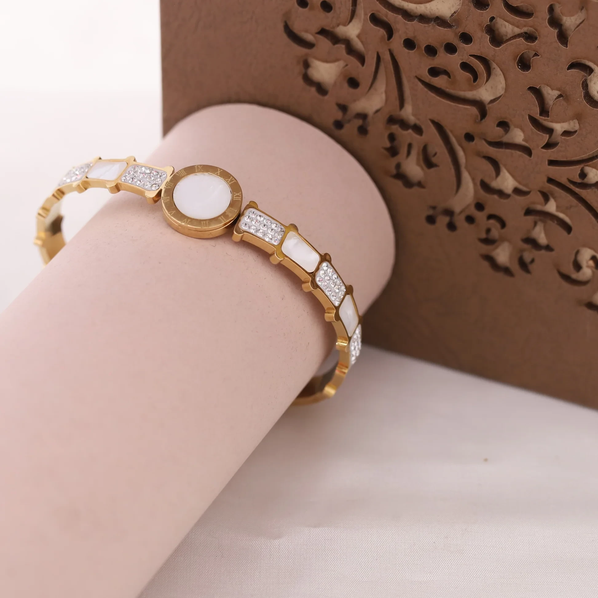 stainless steel gold-plated mother of pearl Roman numerals AD studded bracelet.