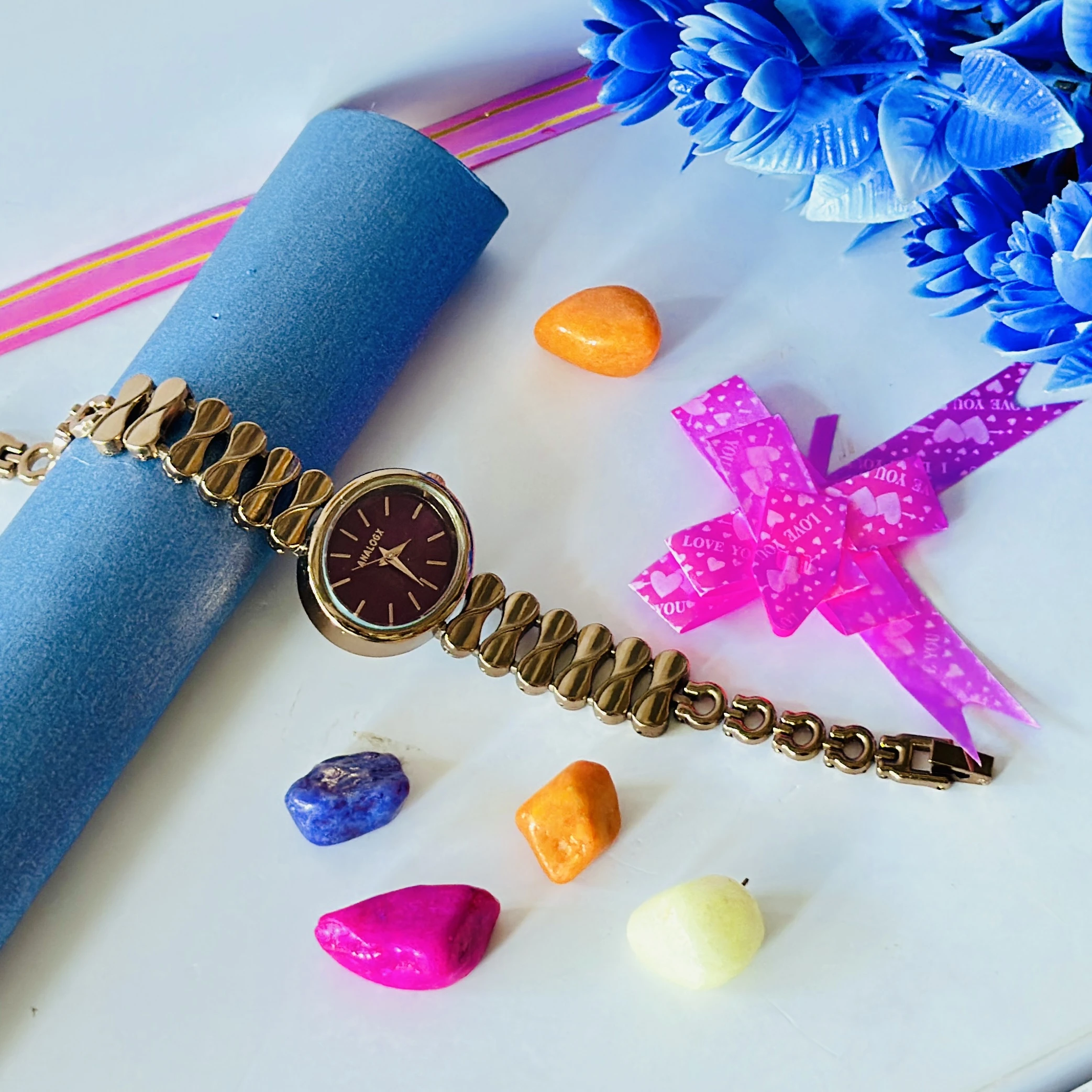 gold-tone Analogx brand women's analog wristwatch with a unique link bracelet.