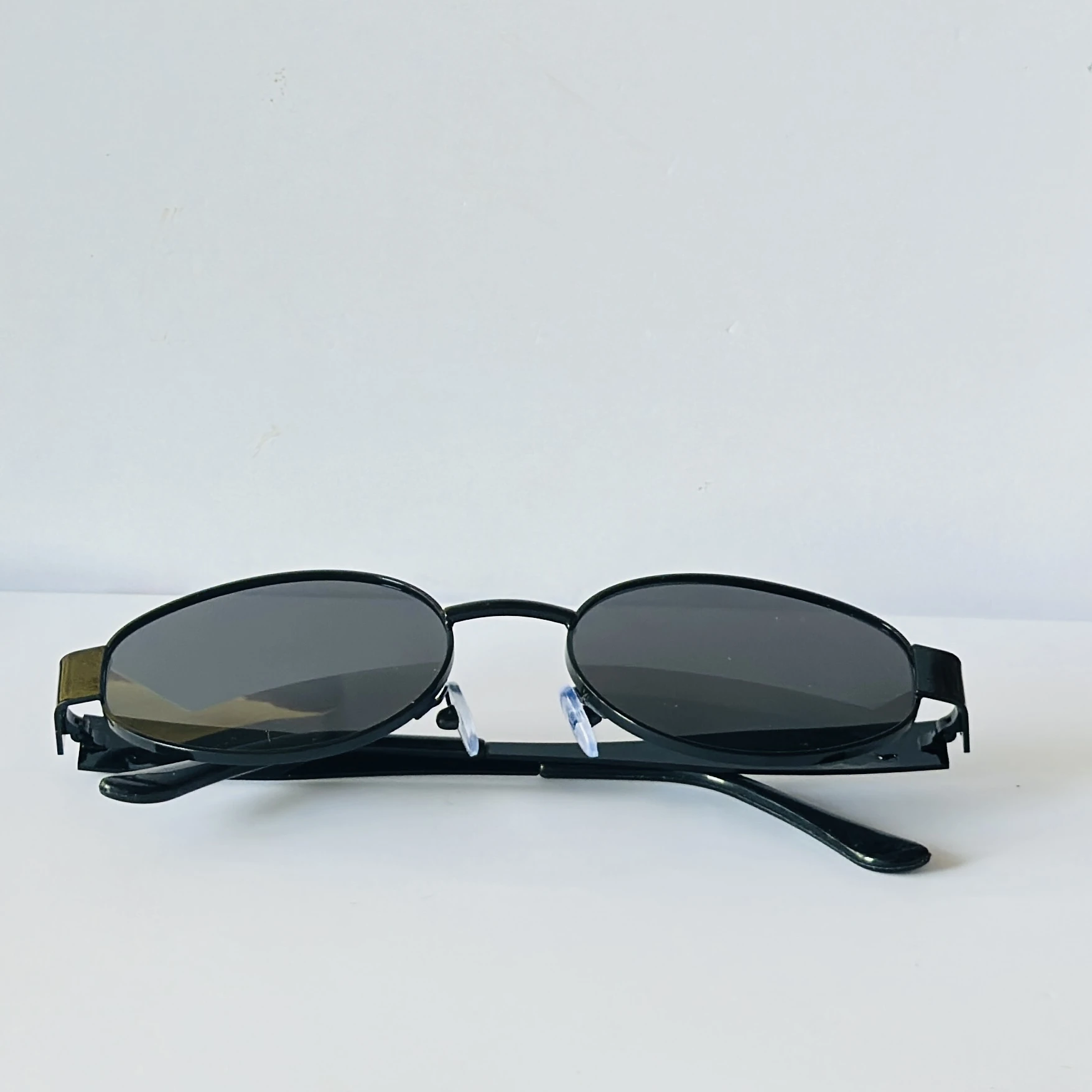 Black sunglasses feature a metal frame and black lenses