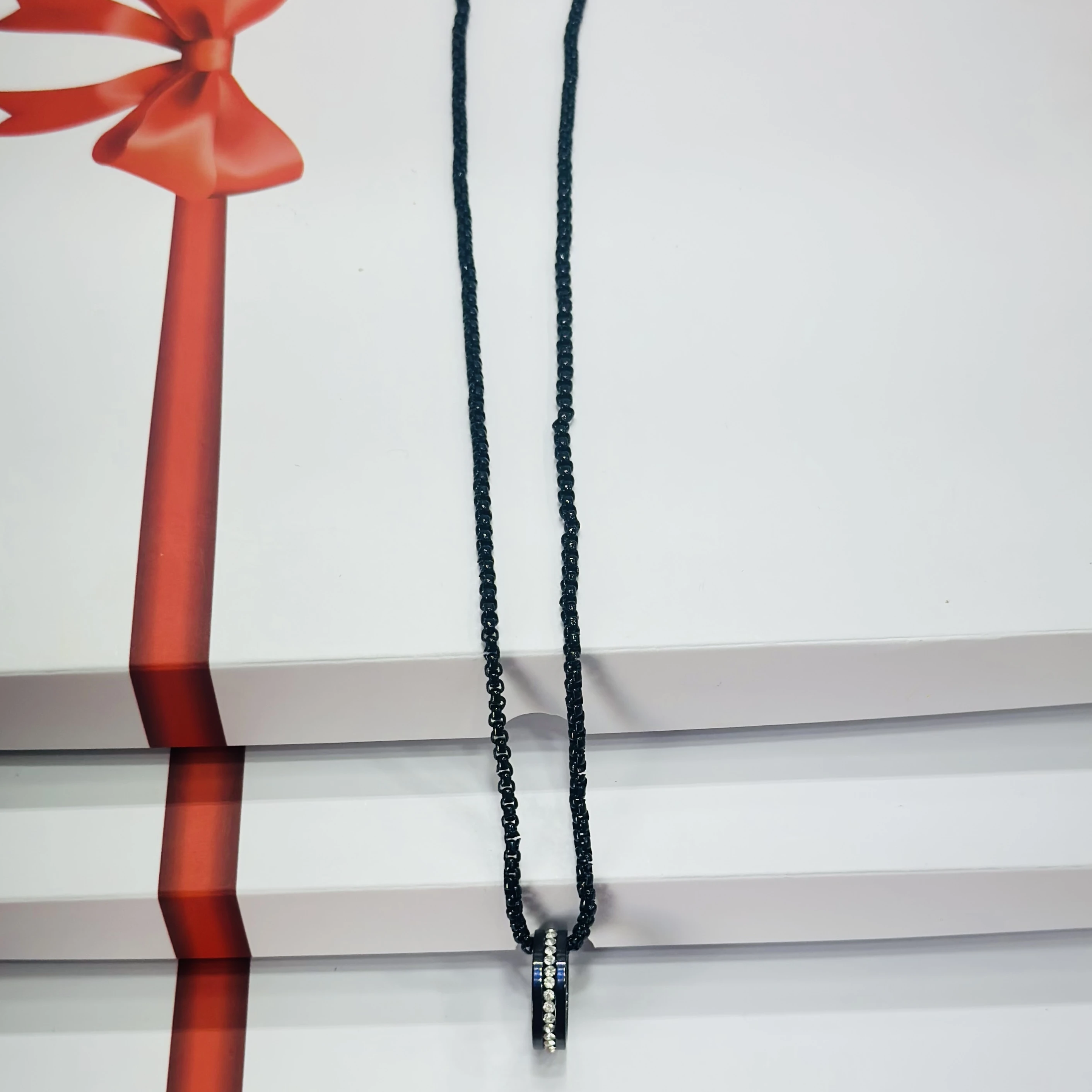 Black beaded necklace with a ring pendant