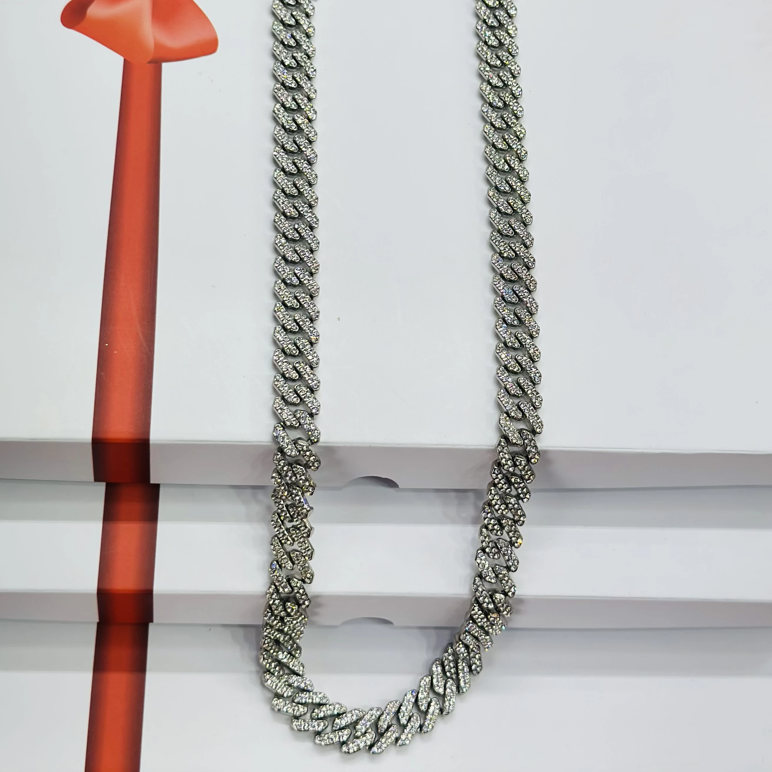 An iced-out silver-plated Cuban link chain necklace with cubic zirconia stones.