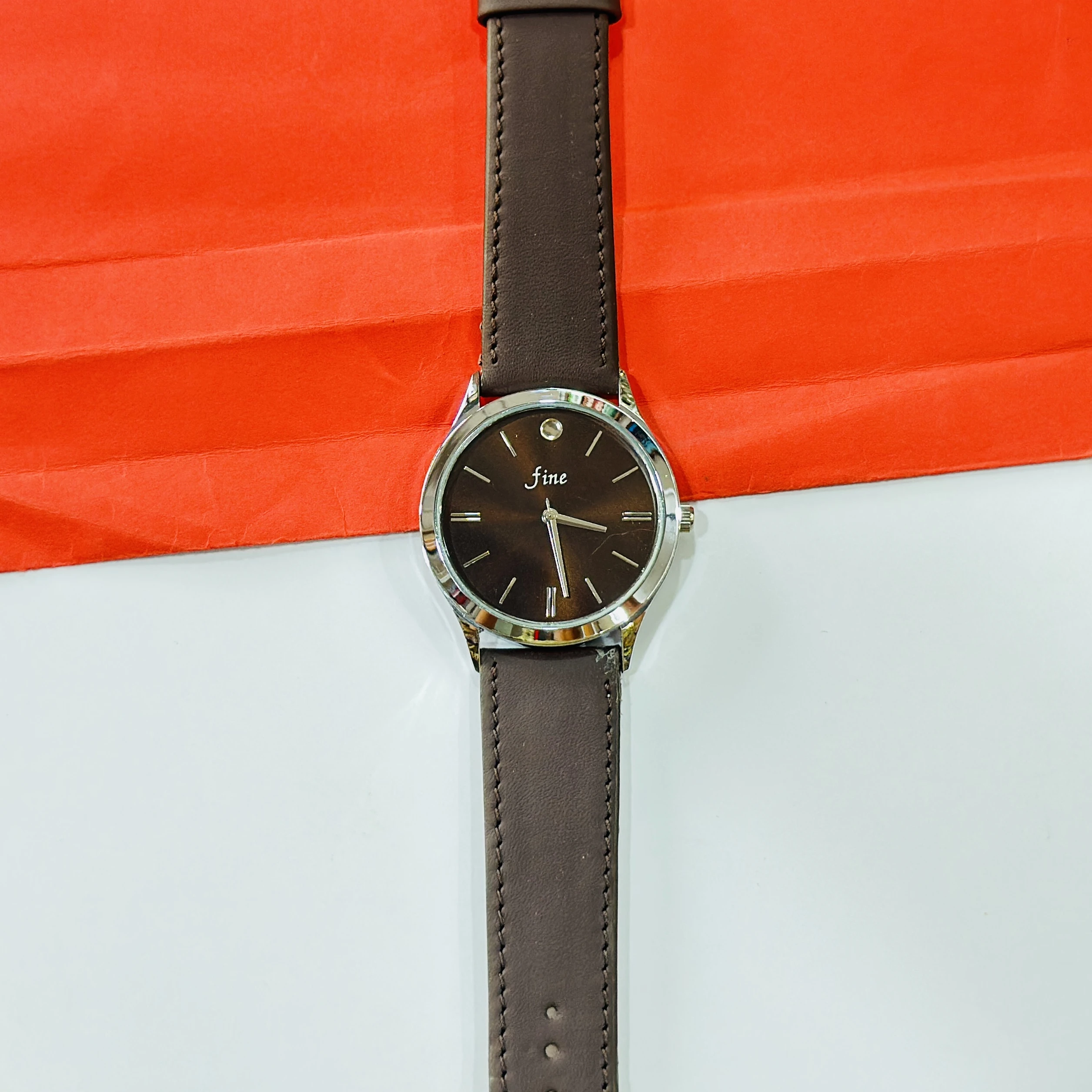 wristwatch with a brown leather band