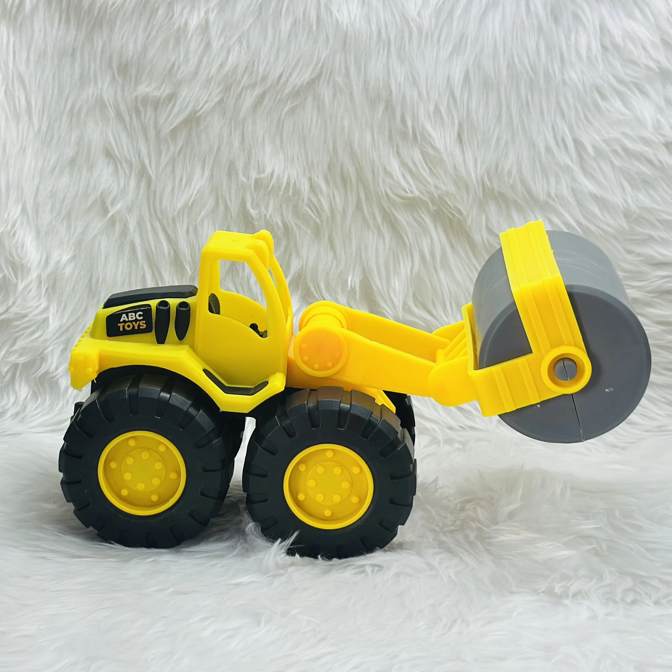 Yellow ABC Toys plastic road roller toy.