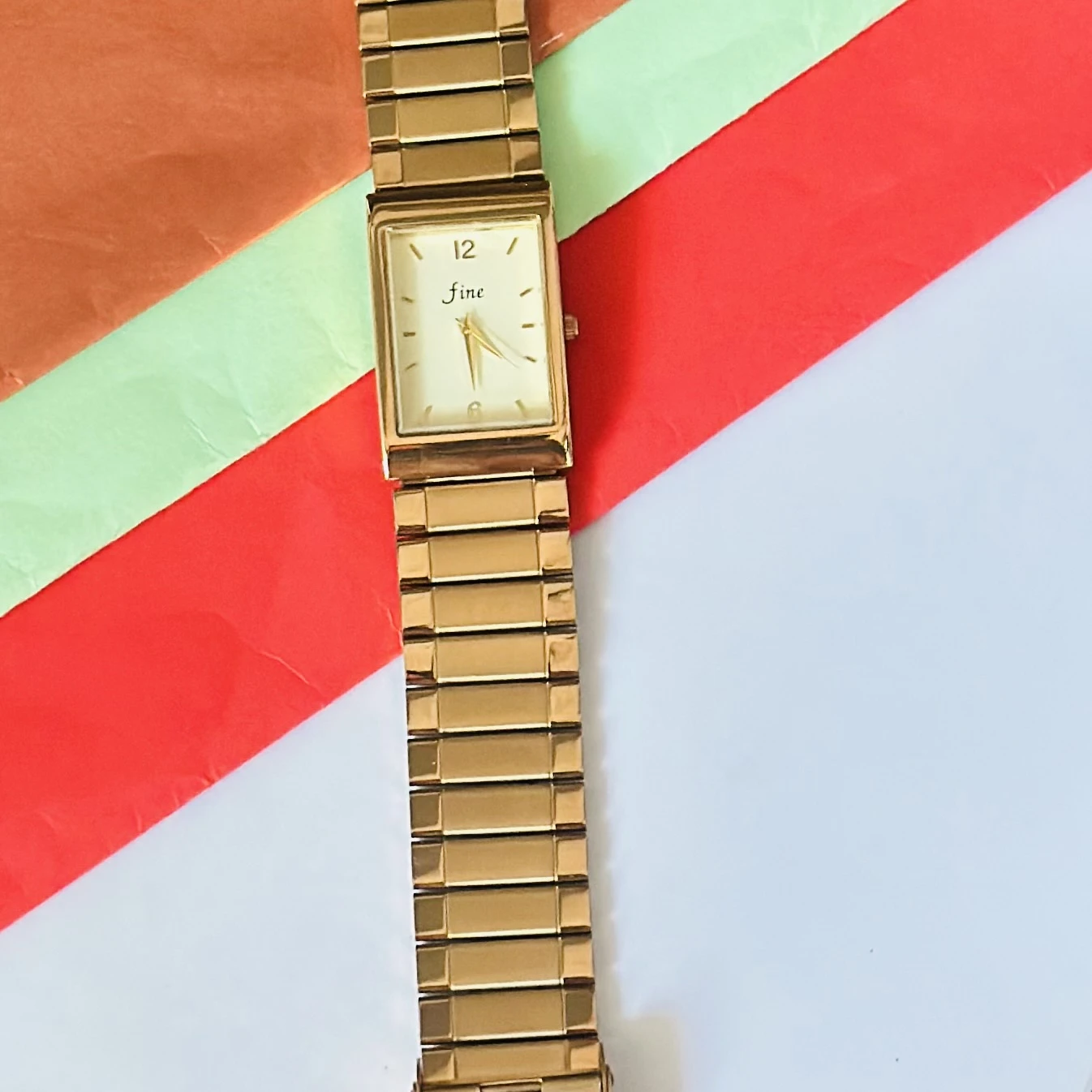Gold -tone analog quartz watch with a metal strap.
