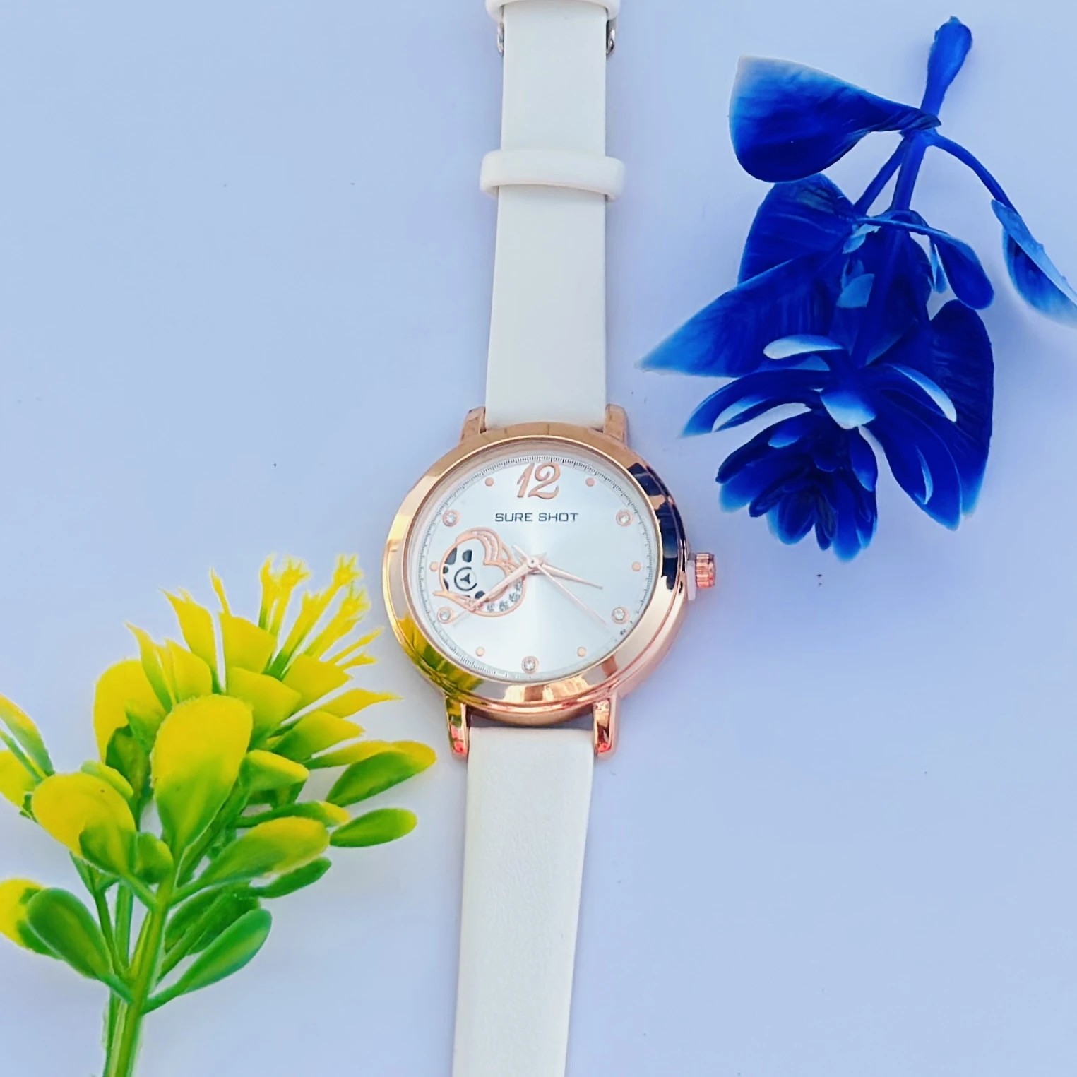 Sure Shot women's analog watch with a rose gold case, white dial, and white silicone strap