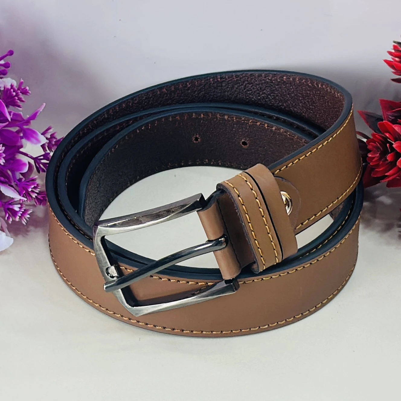 Brown leather belt with a metal buckle