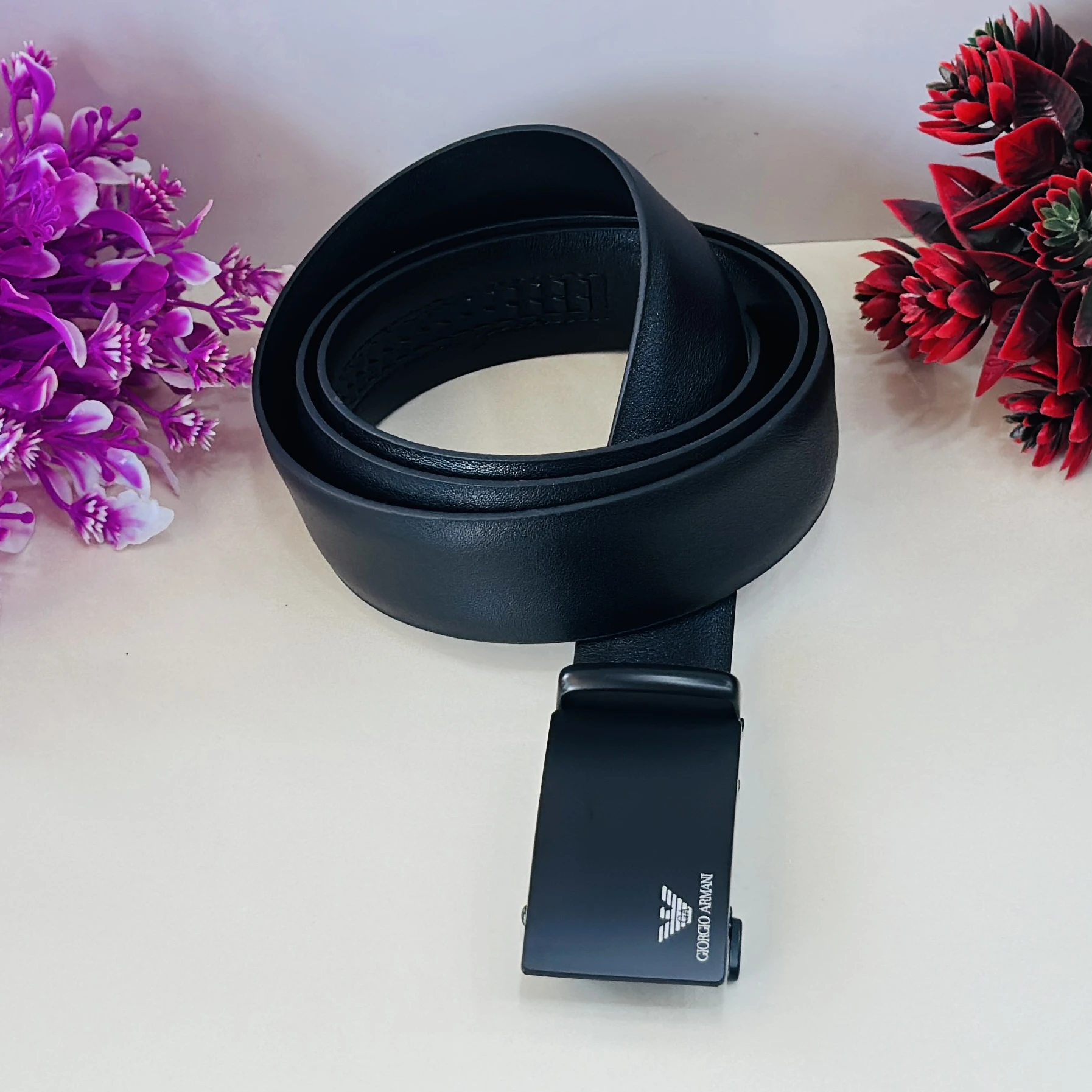 Emporio Armani black leather belt with a logo plaque buckle.