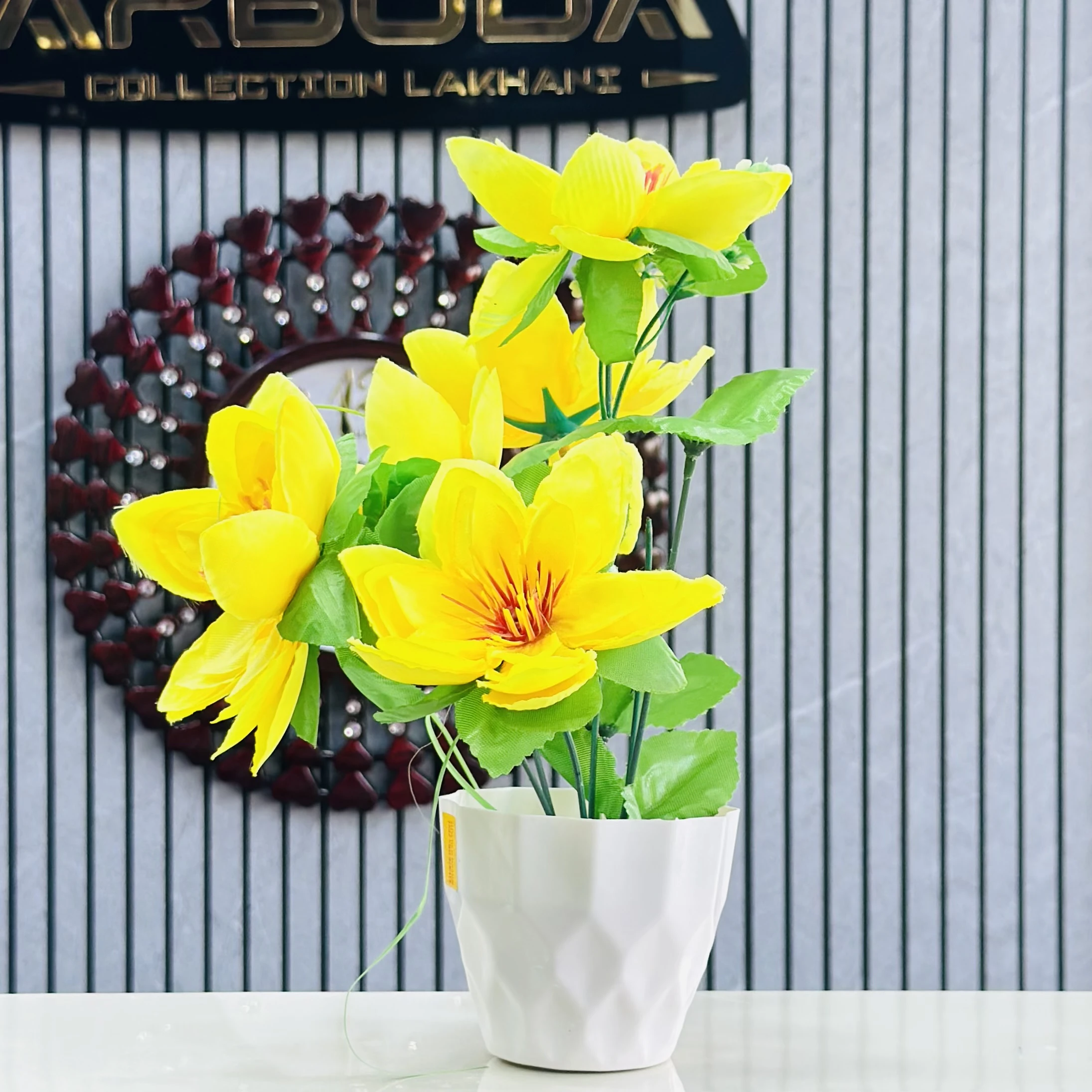 Yellow lily flower plant in a white pot.
