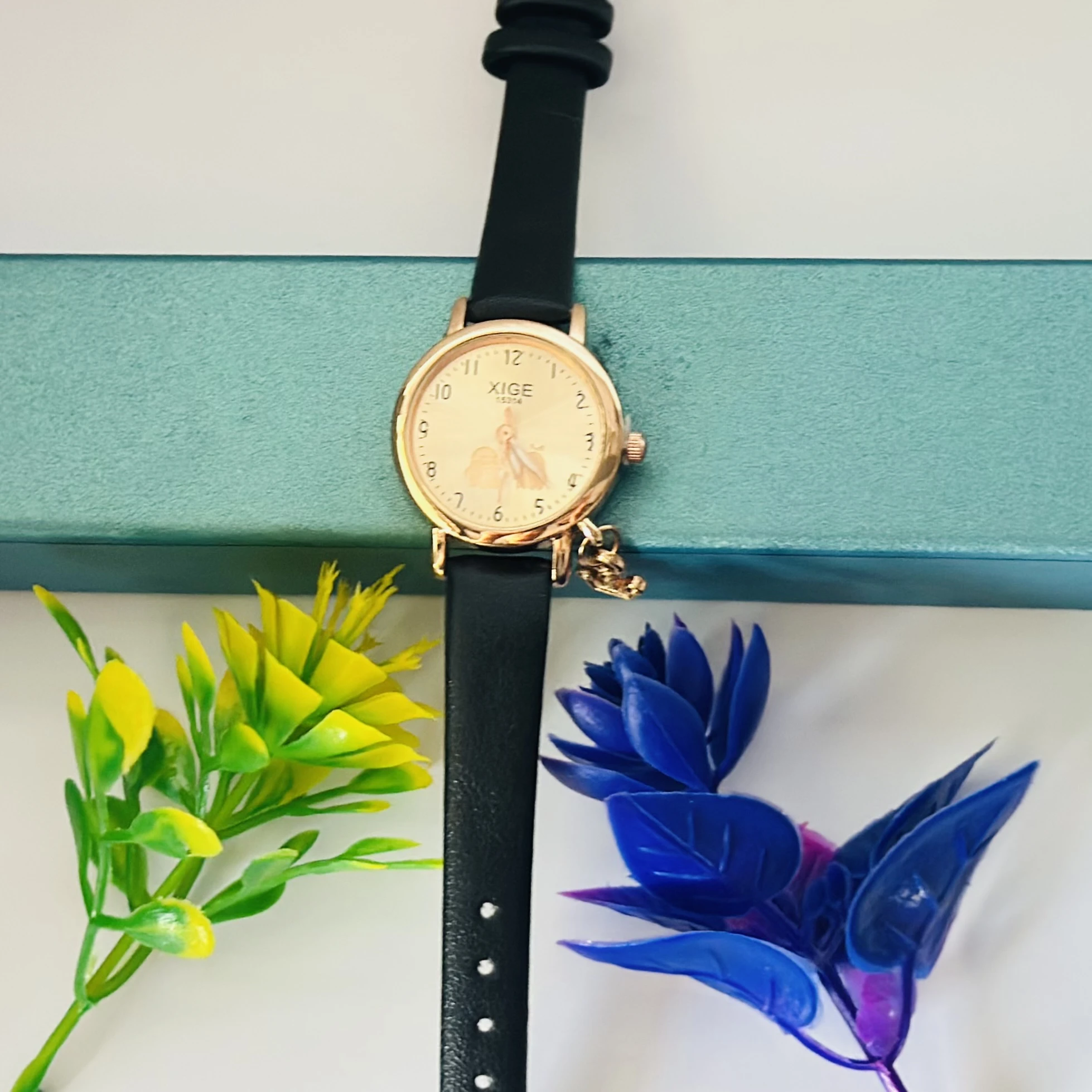 Quartz watch with a black leather band and a rose gold-tone case.