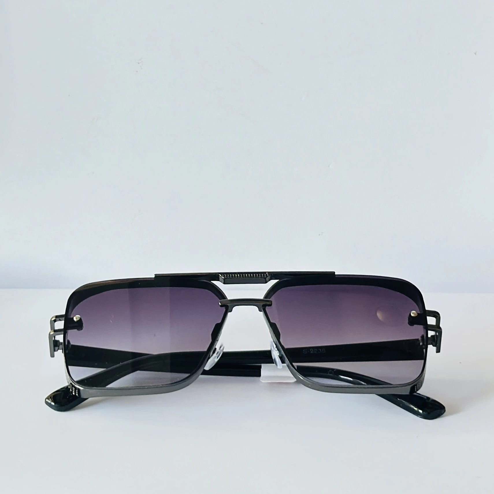 appear to be retro square or modern pilot-style sunglasses for men
