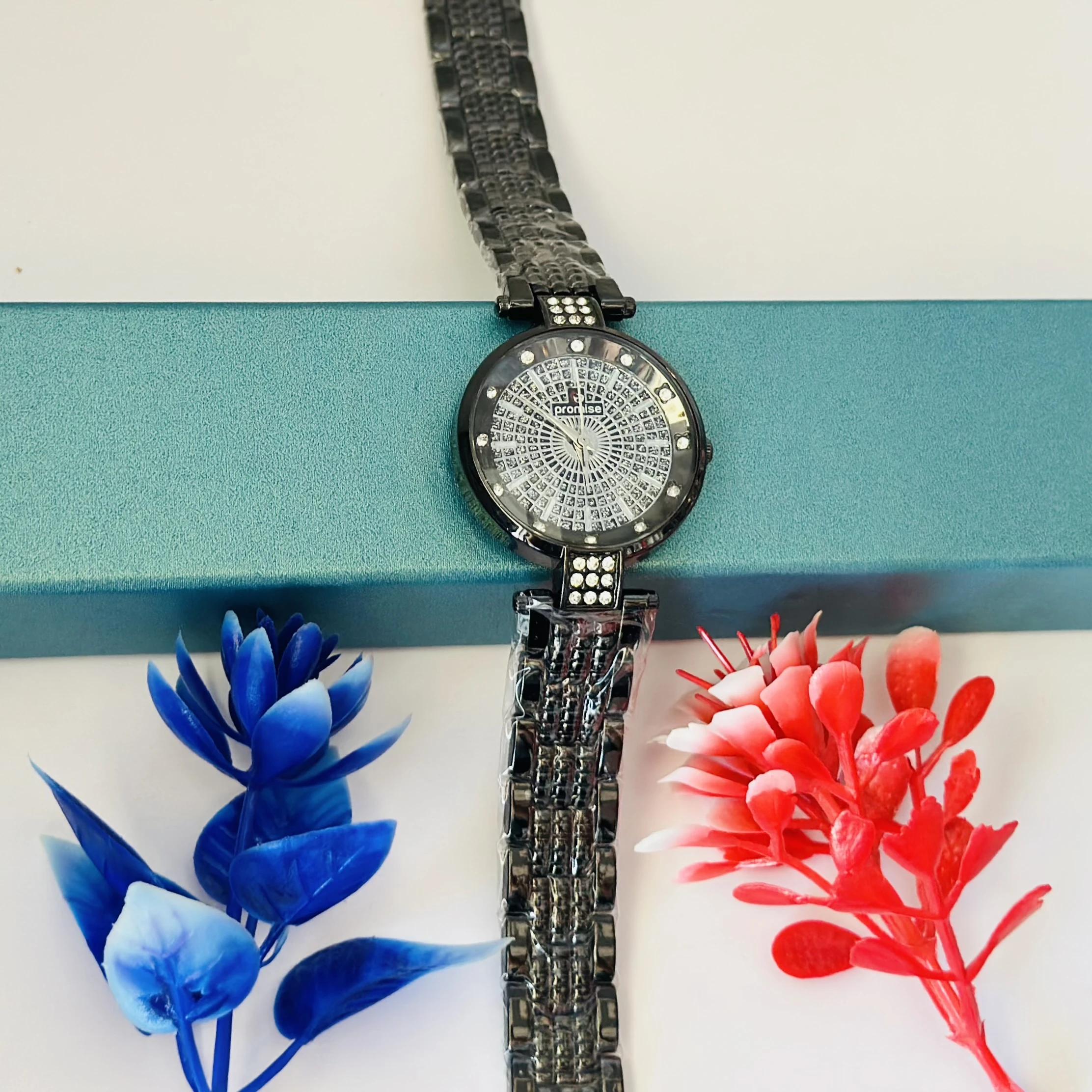 Ladies fashion watch with a black metal strap.