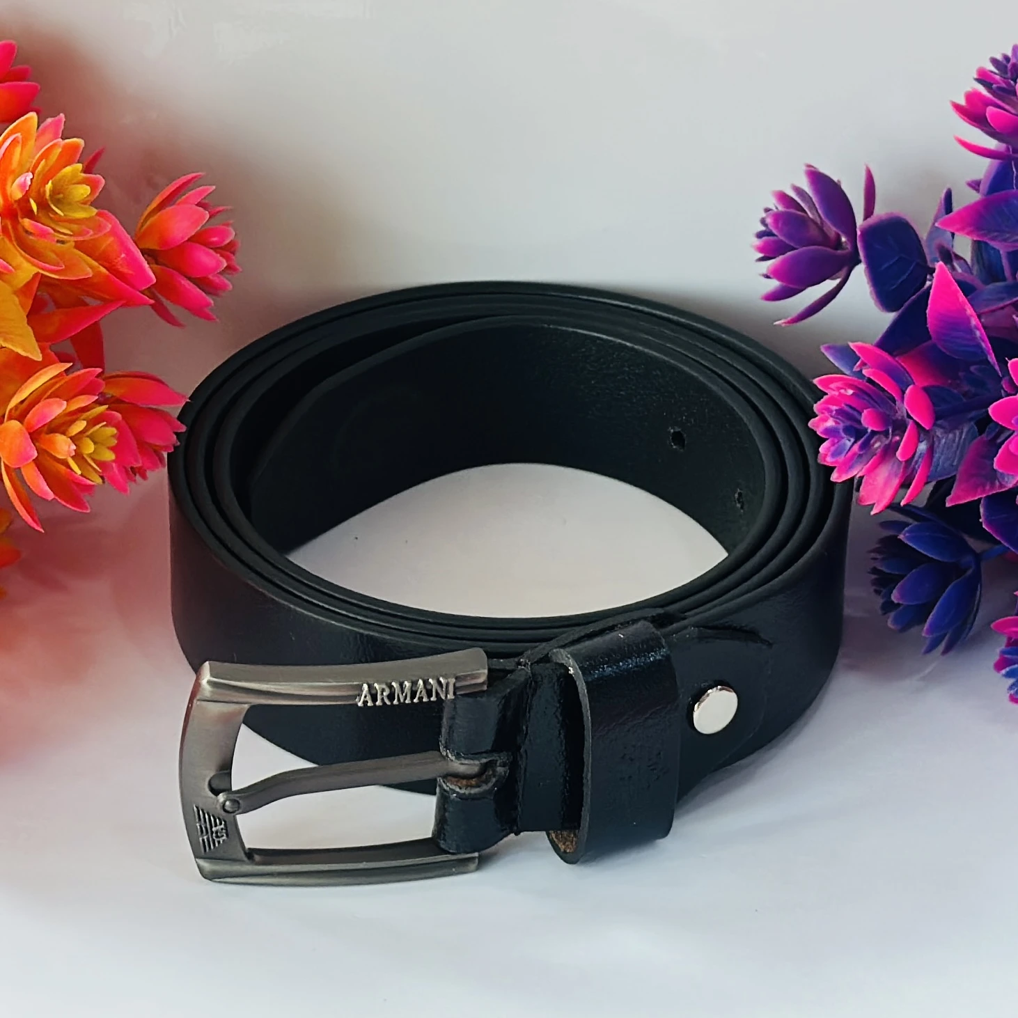 Black leather belt with a gunmetal buckle.