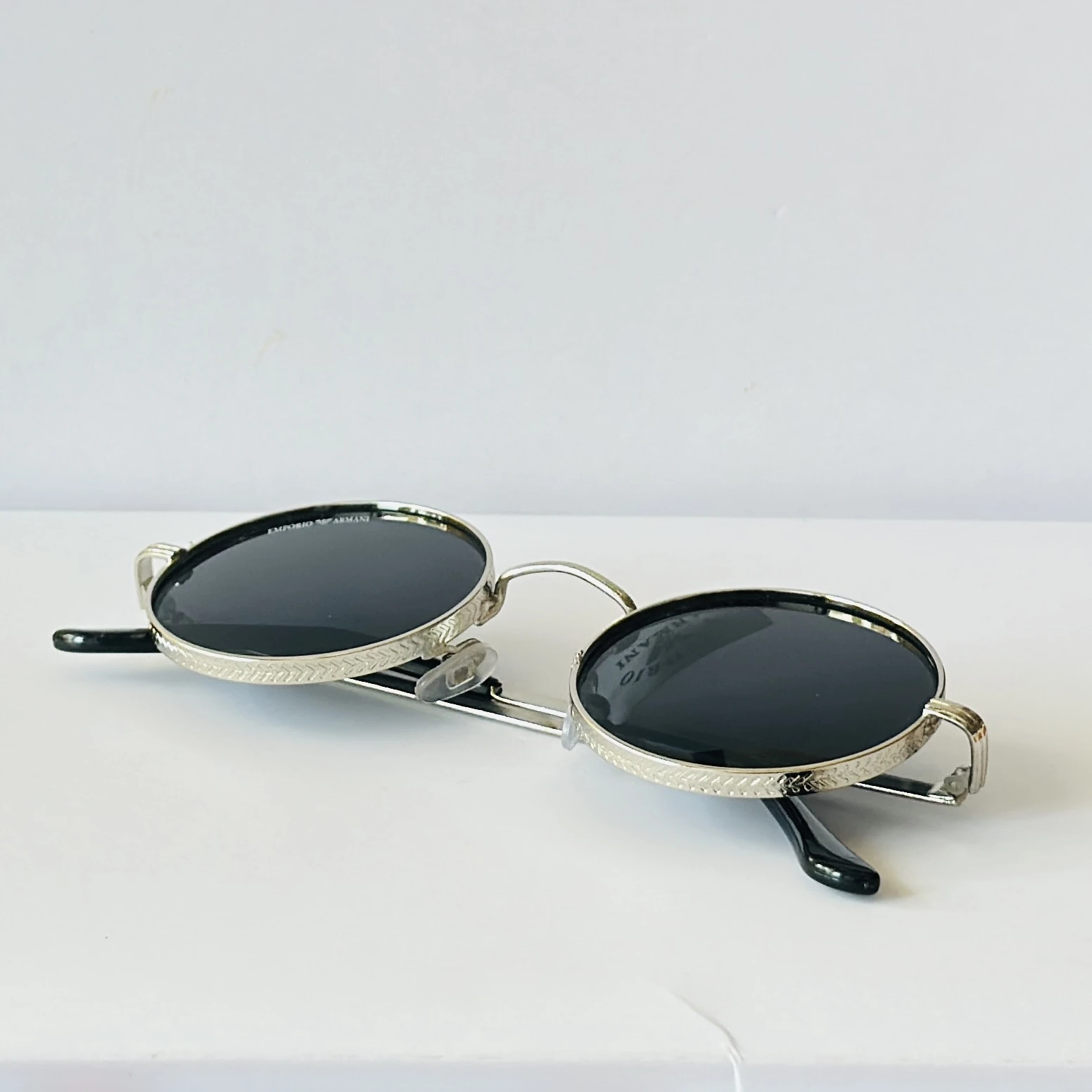 Emporio Armani sunglasses feature a distinctive round metal frame design.