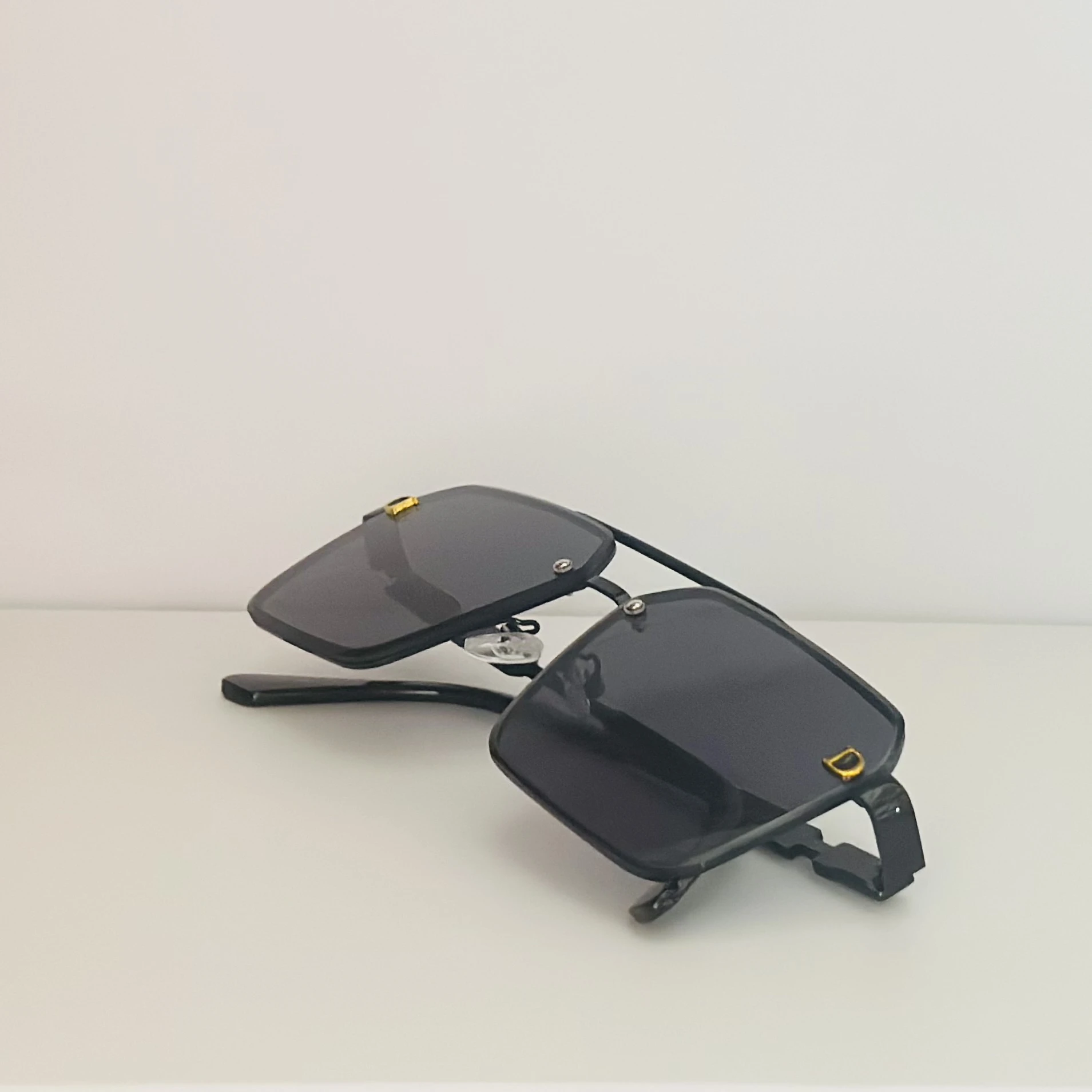 black pilot-style sunglasses with grey polycarbonate lenses.