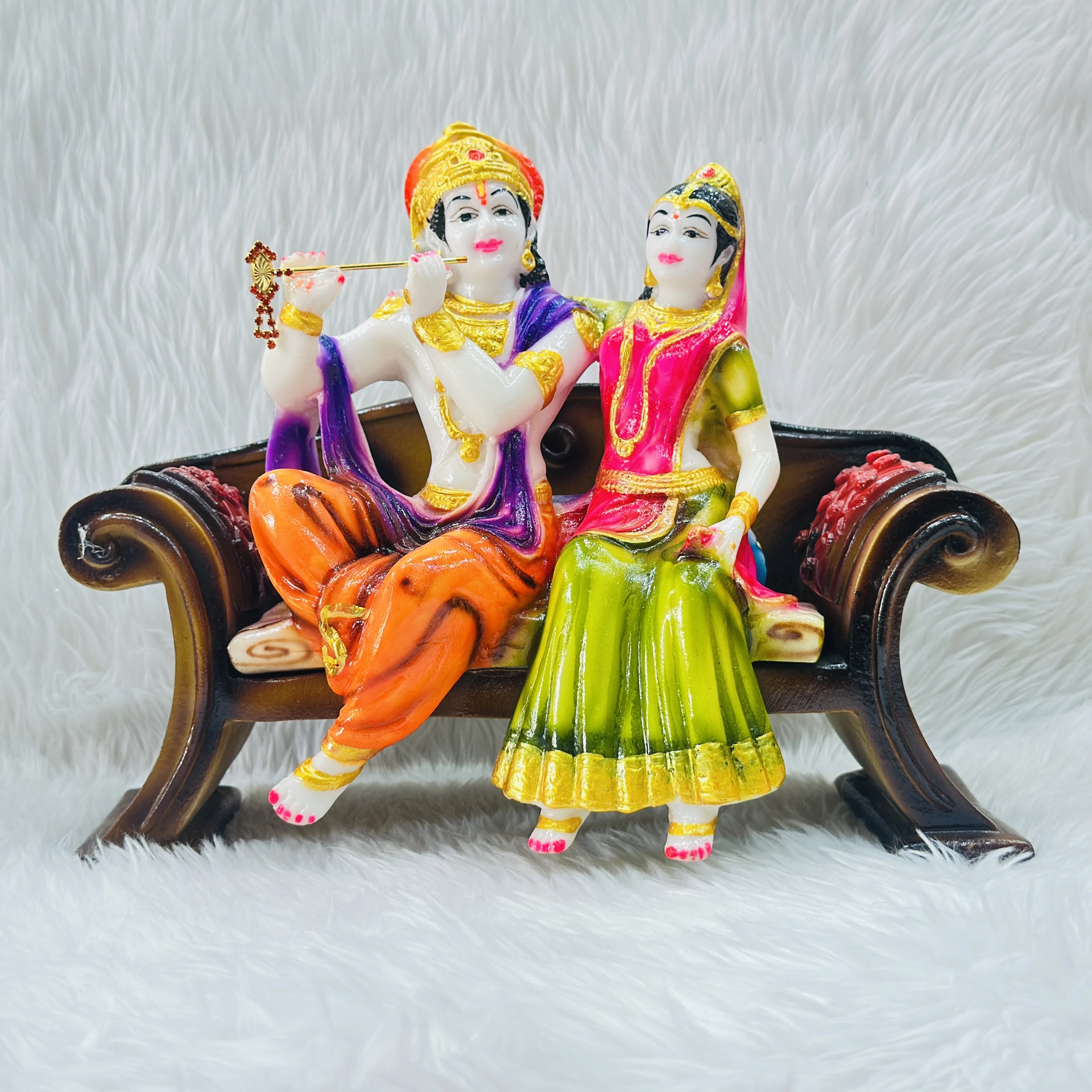 polyresin and fiberglass handicraft idol of Radha Krishna sitting on a decorative bench