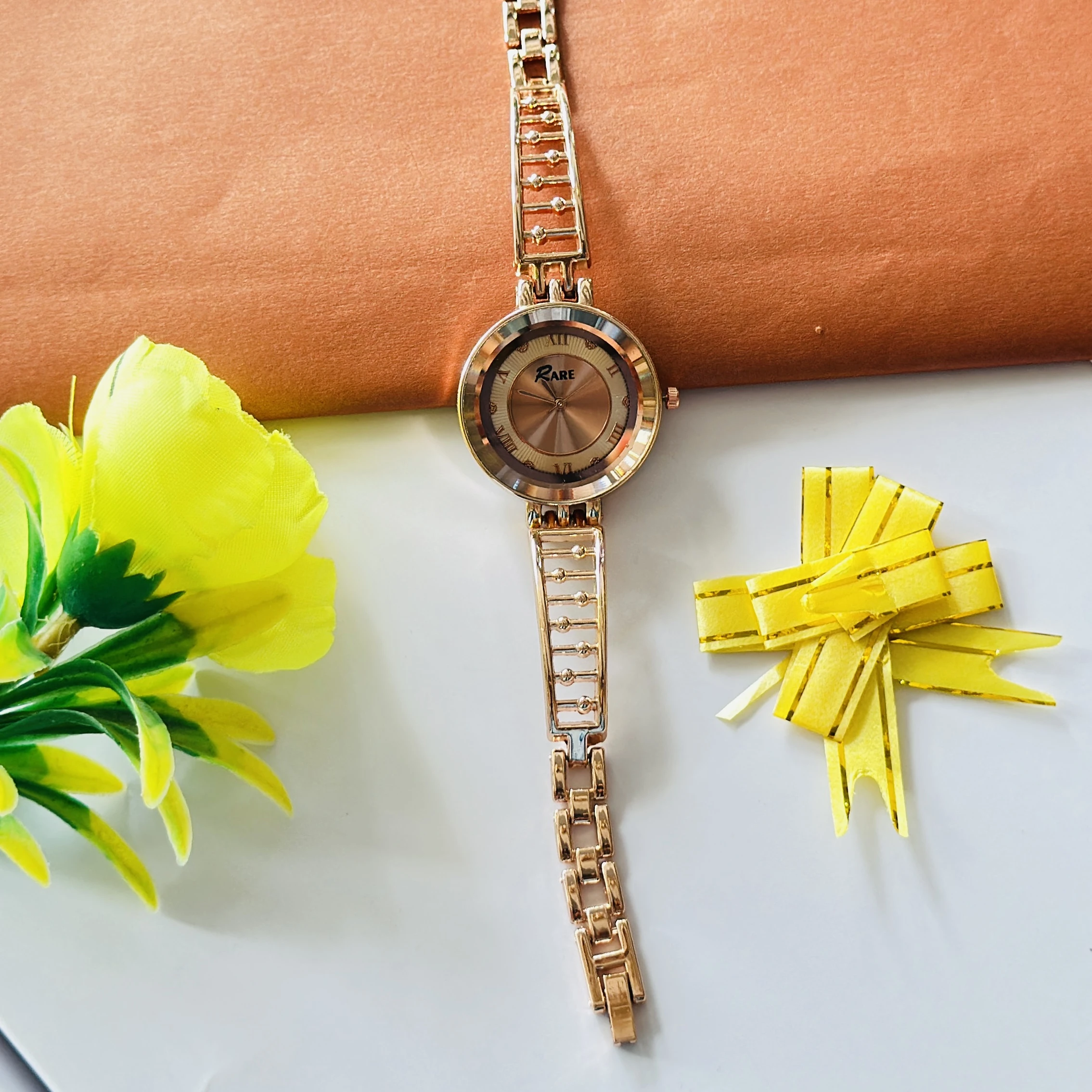 Raga women's rose gold analog wristwatch with a unique bracelet design